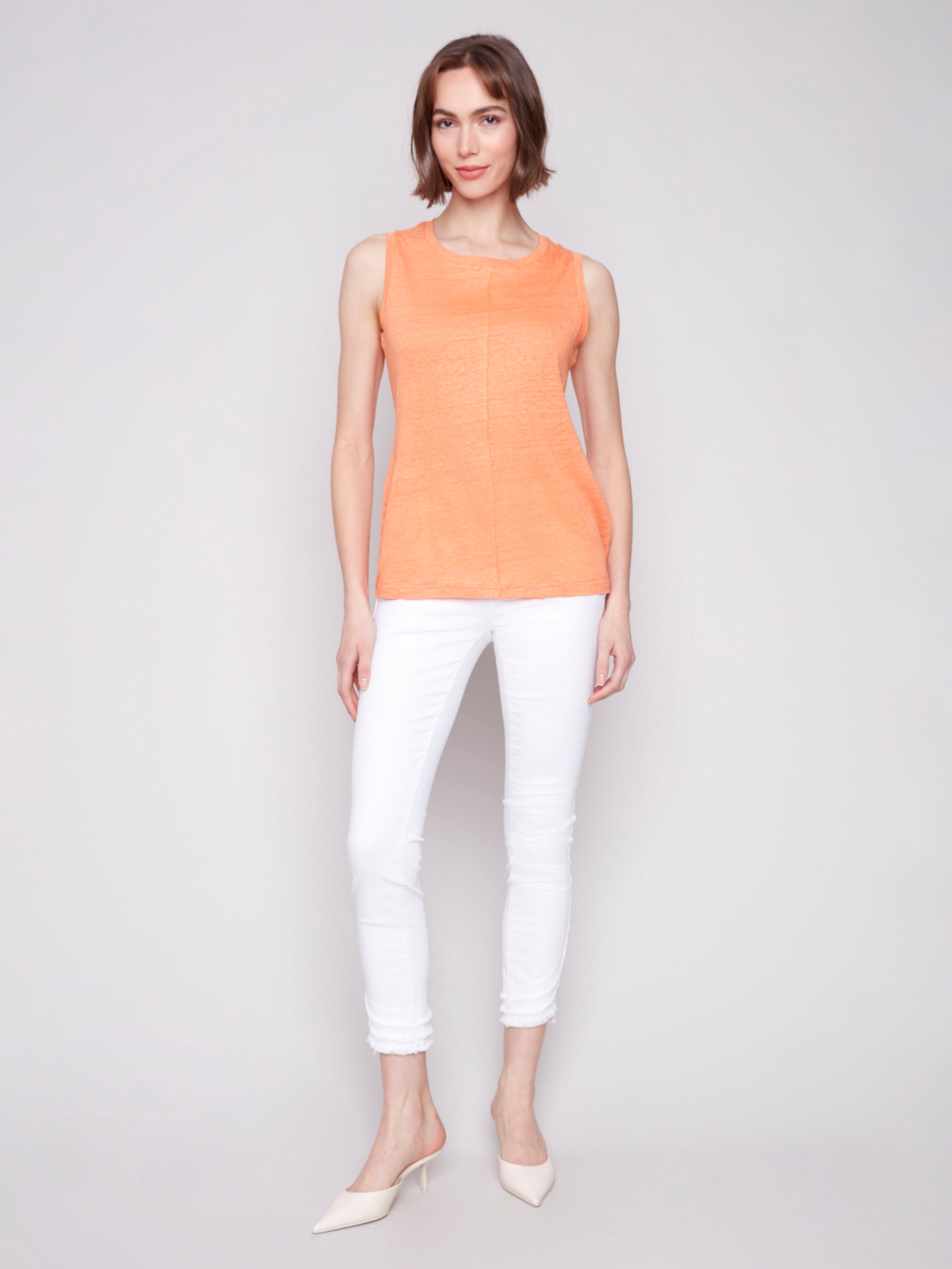 Elegant papaya sleeveless top with unique front seam detail by Charlie B.