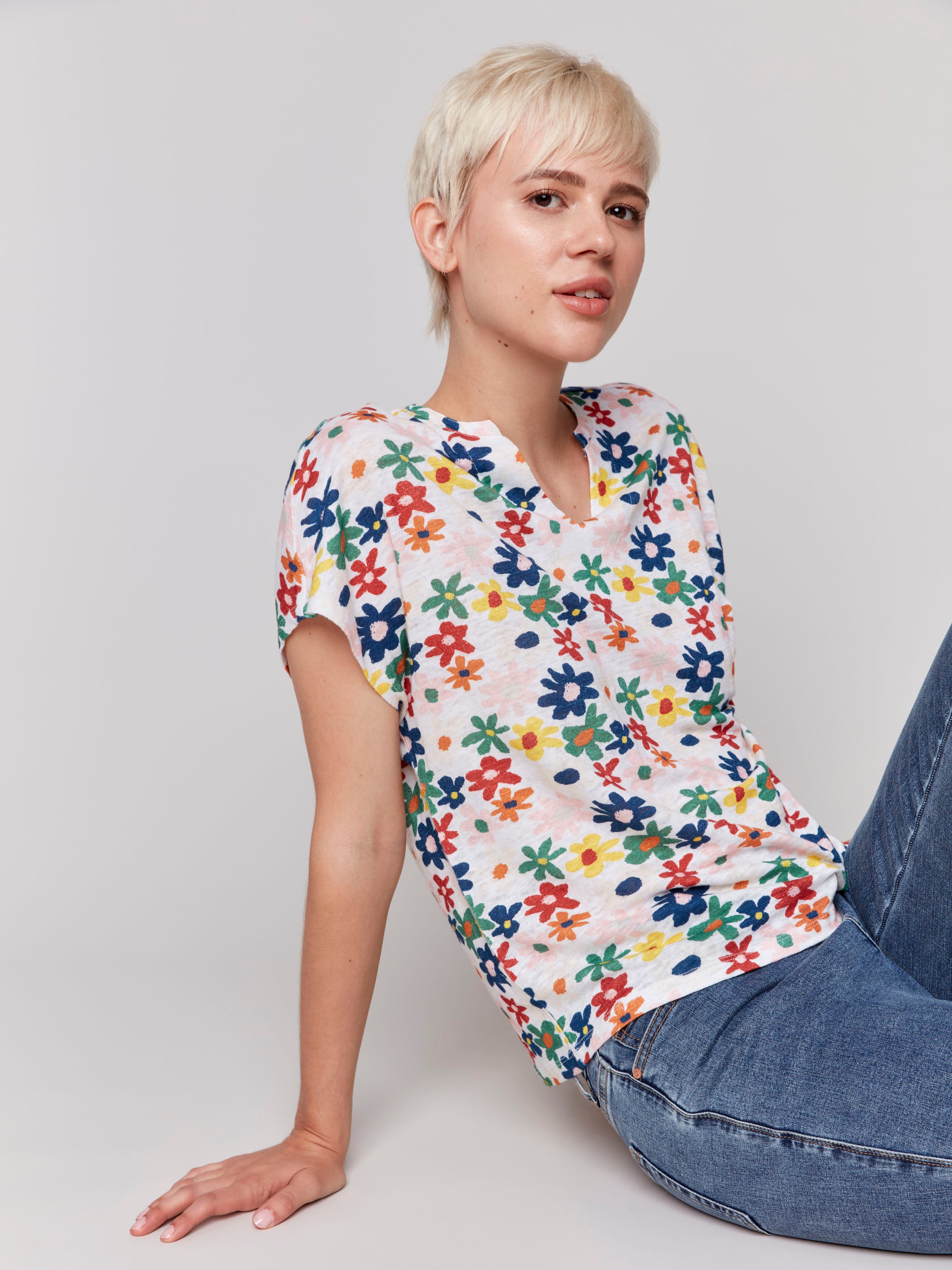 Chic split neckline top with daisy motifs, ideal for warm weather by Charlie B.