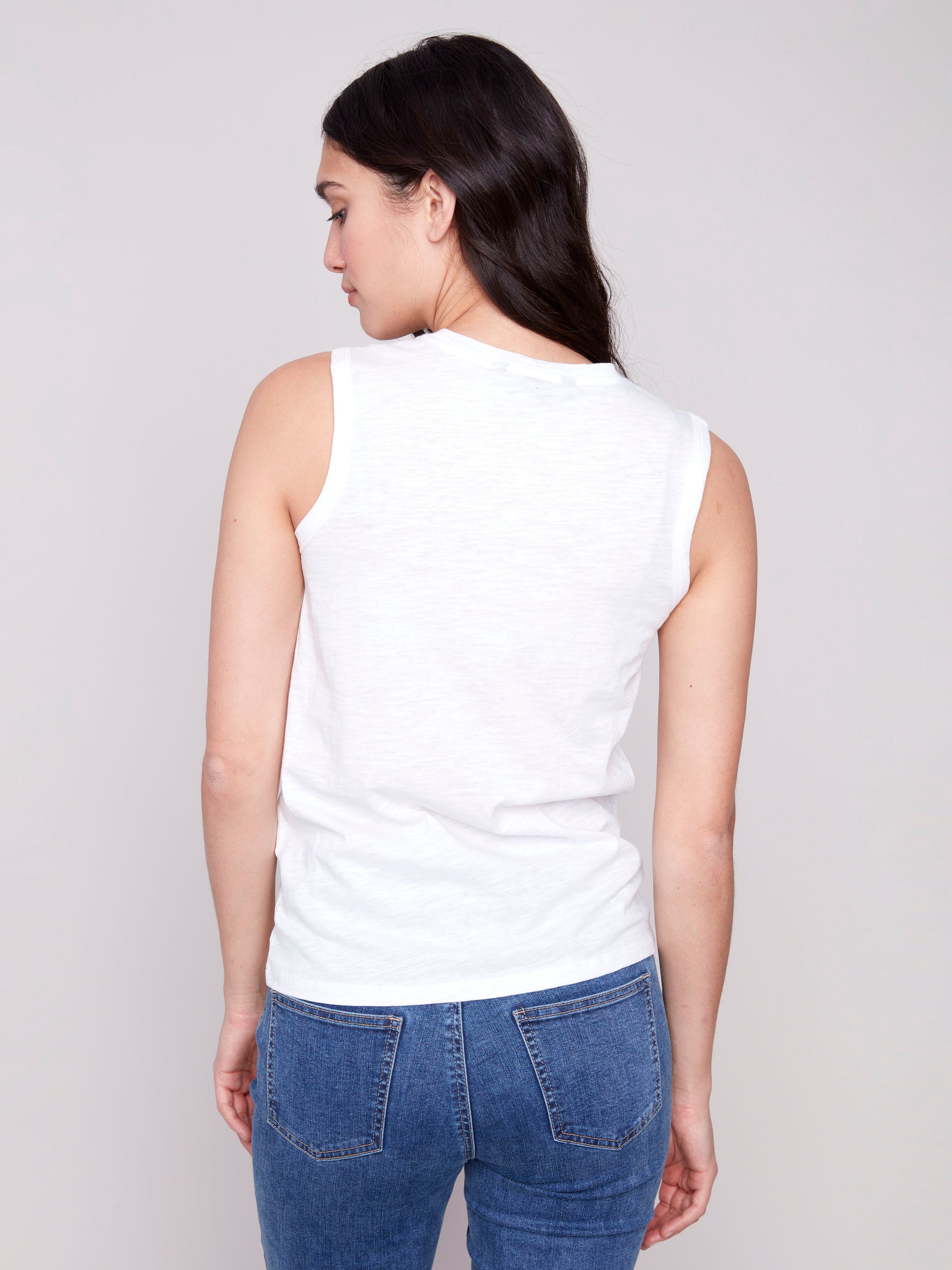 Chic white tank top adorned with heart cut-out detail by Charlie B.