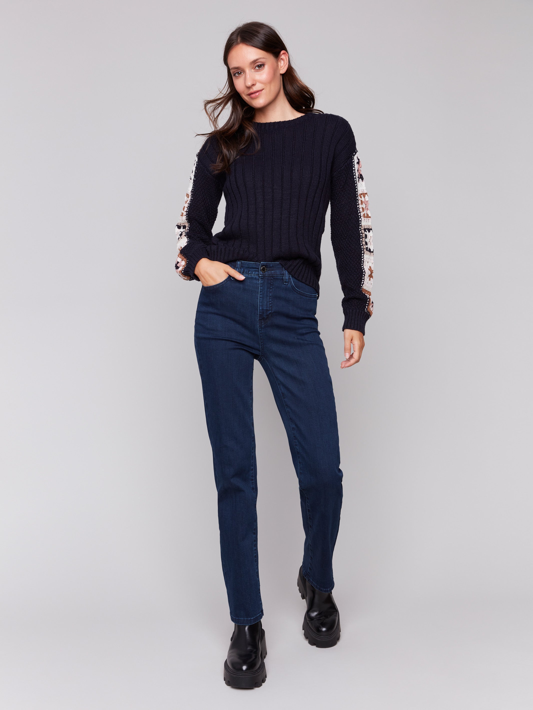 Navy blue long-sleeve sweater with detailed crochet pattern on the sleeves by Charlie B.