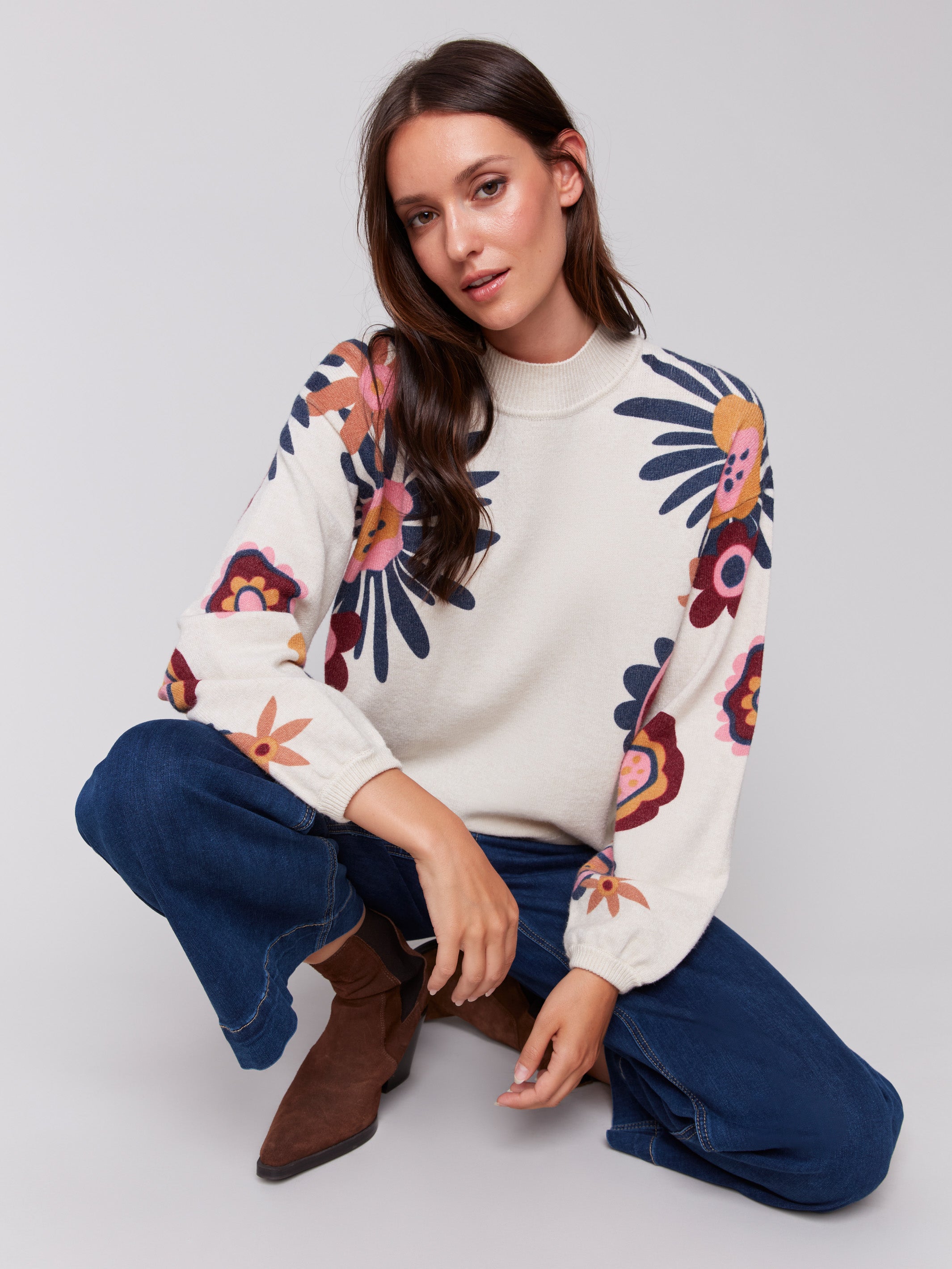 Creamy beige mock neck sweater with vibrant floral print, featuring long sleeves and a cozy knit texture by Charlie B.