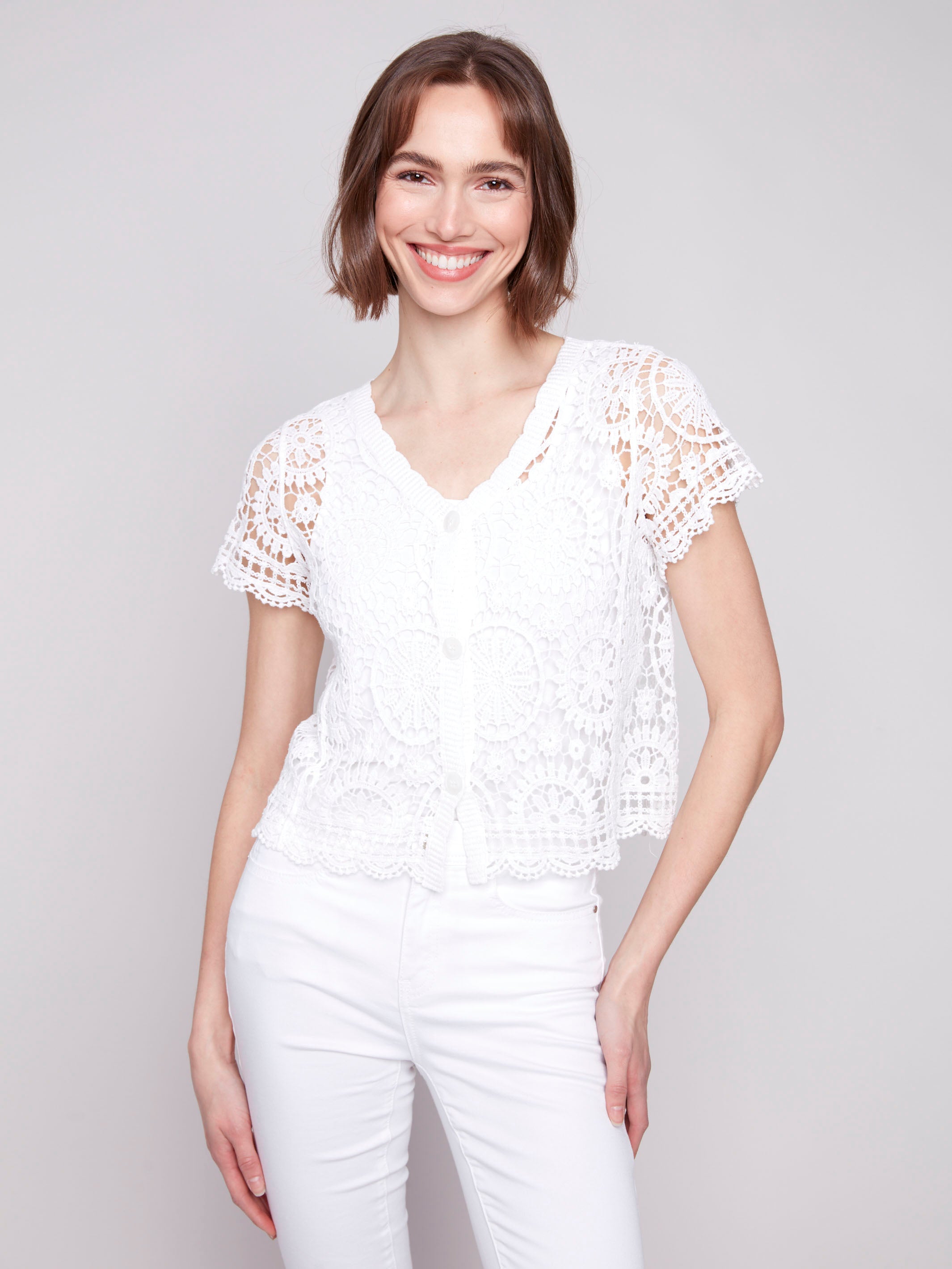 Button front white bolero cardigan crafted with exquisite crochet design by Charlie B.