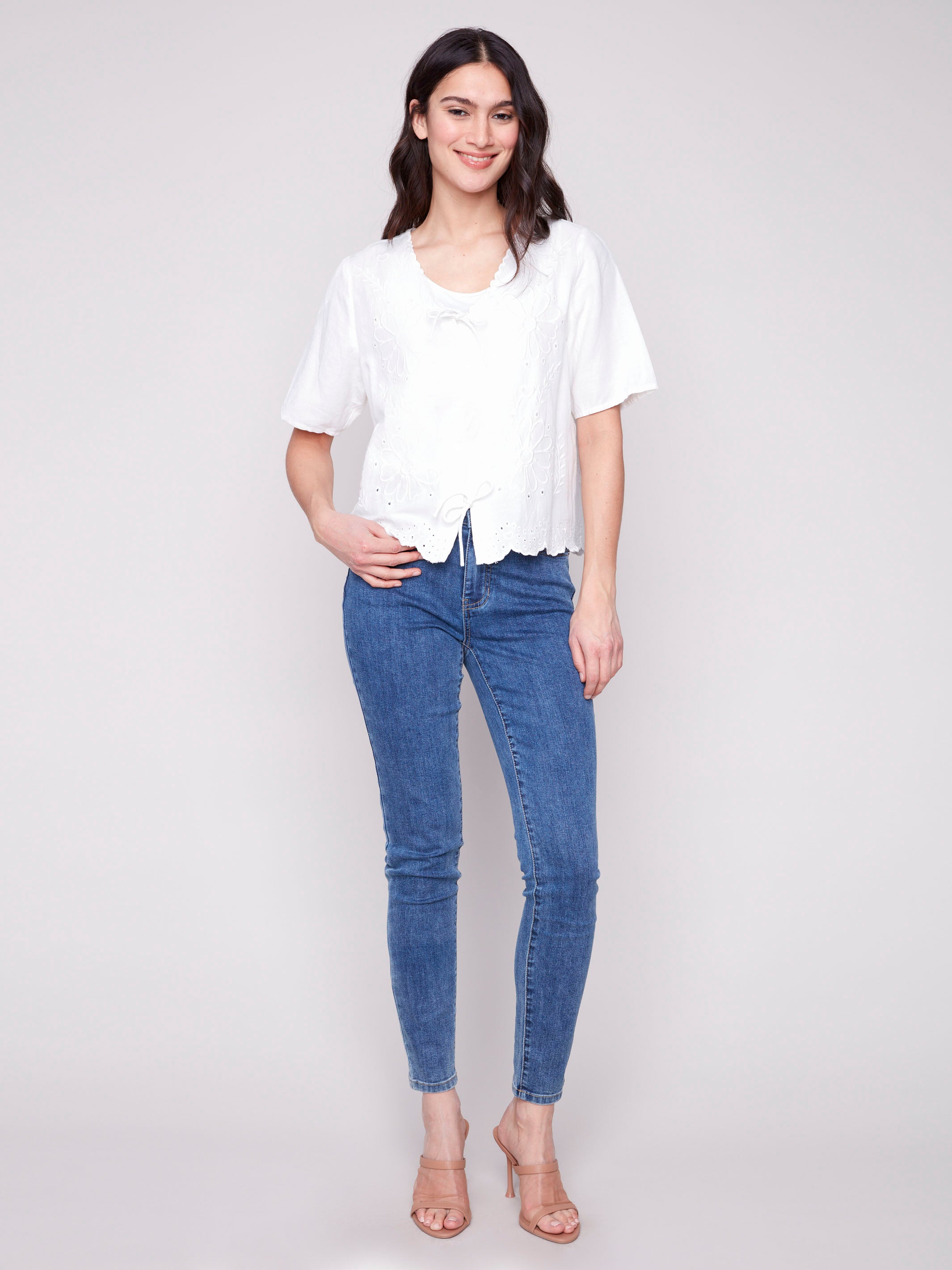 White blouse with front tie closures and scalloped hem detailing by Charlie B.