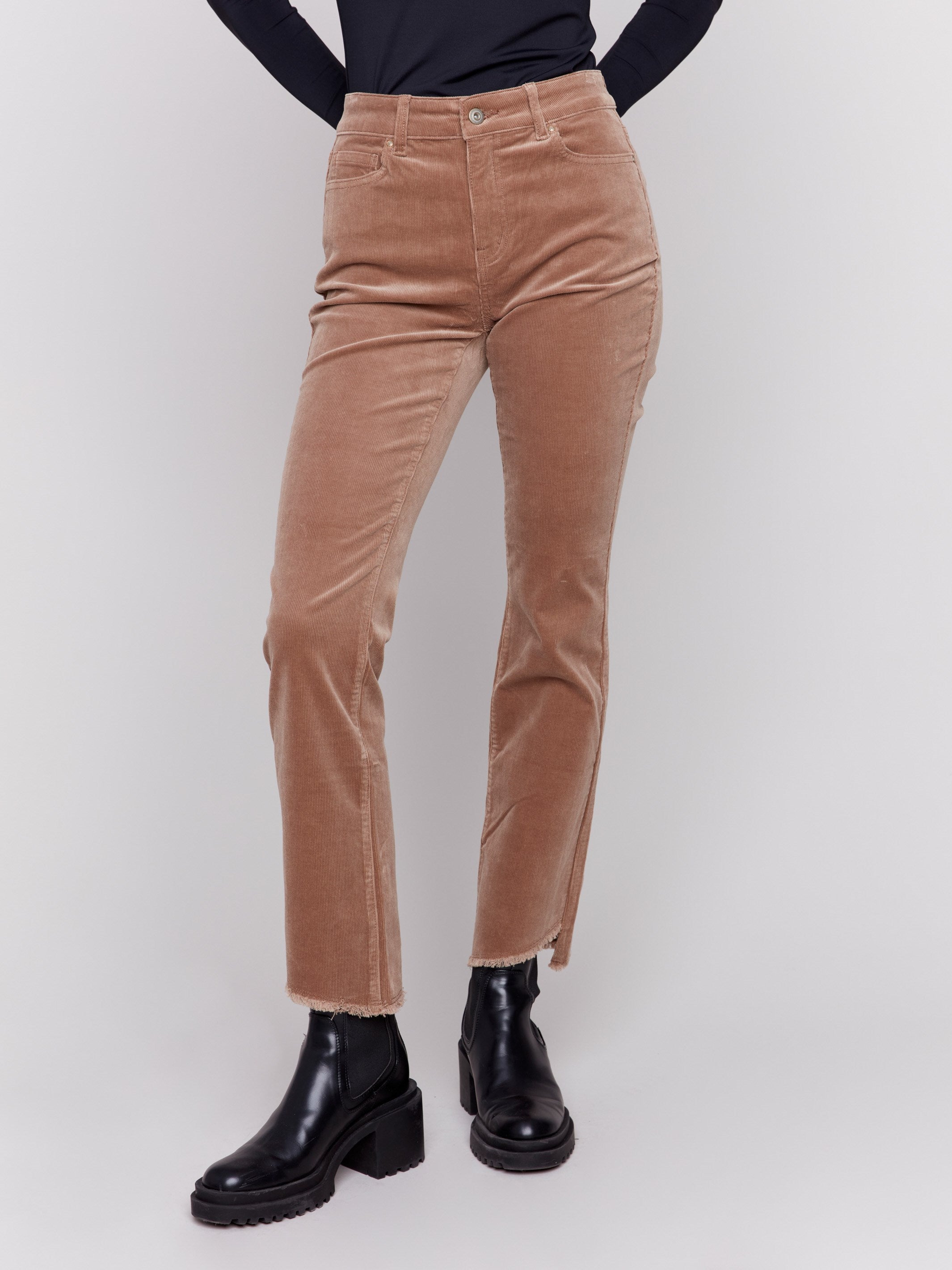 Truffle-colored bootcut corduroy pants with an asymmetrical frayed hem and a bootcut fit by Charlie B.