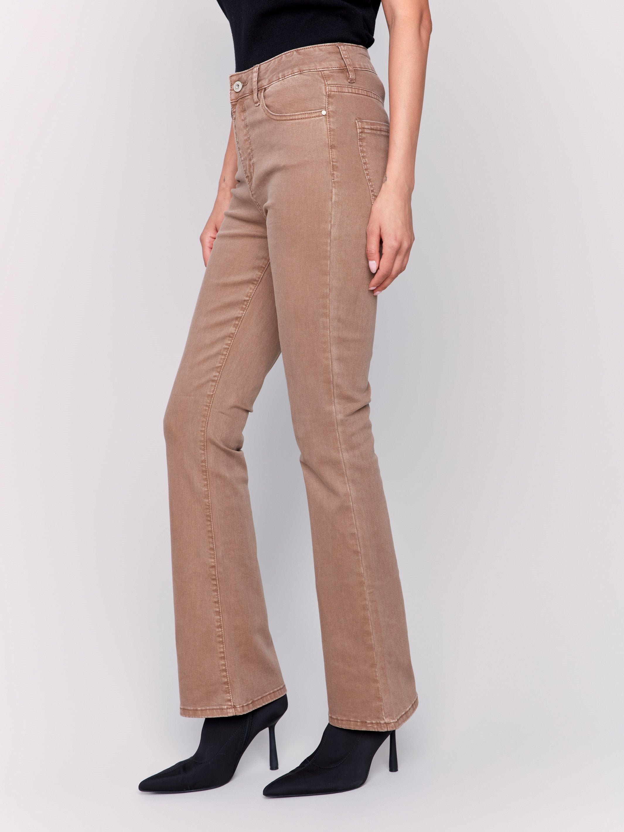 Brown bootcut twill pants with a mid-rise and bootcut fit, showcasing five-pocket design by Charlie B.