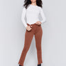 Terracotta red bootcut twill pants with an asymmetrical fringe hem and mid-rise waist by Charlie B.