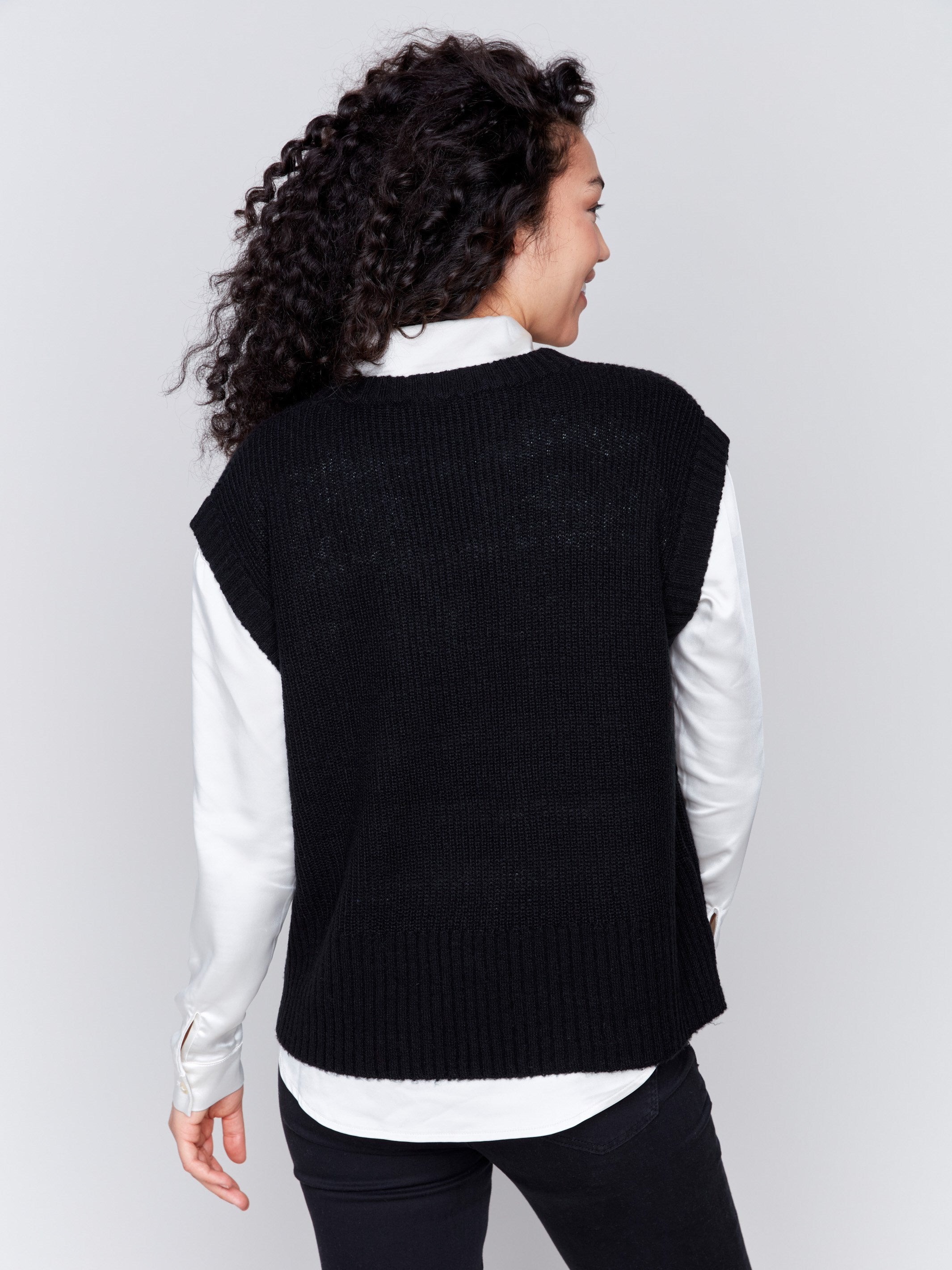 Black soft touch sweater vest with a V-neck and relaxed fit, perfect for layering by Charlie B.