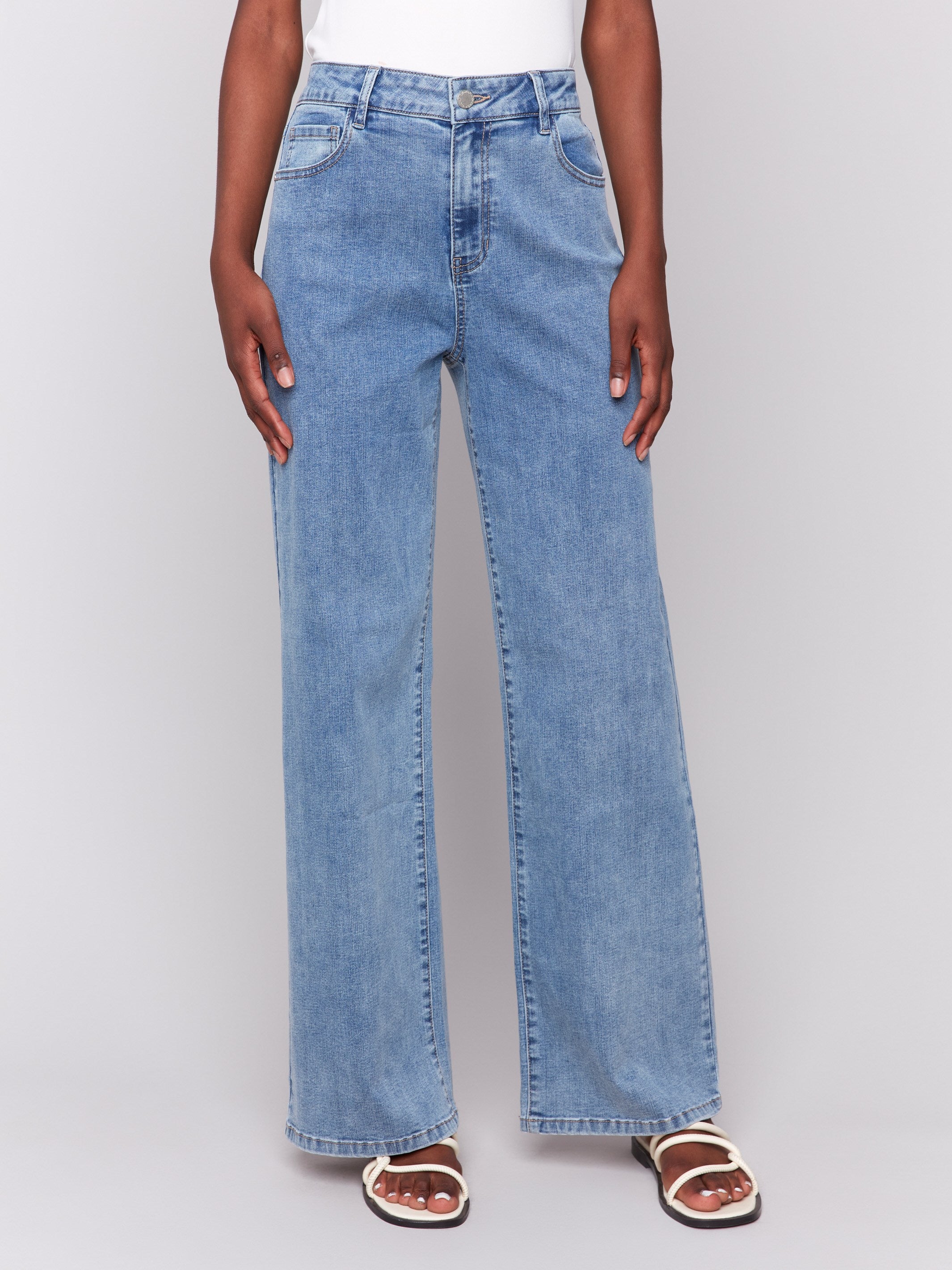 Light blue wide-leg jeans with five-pocket design featuring a button closure and relaxed fit by Charlie B.