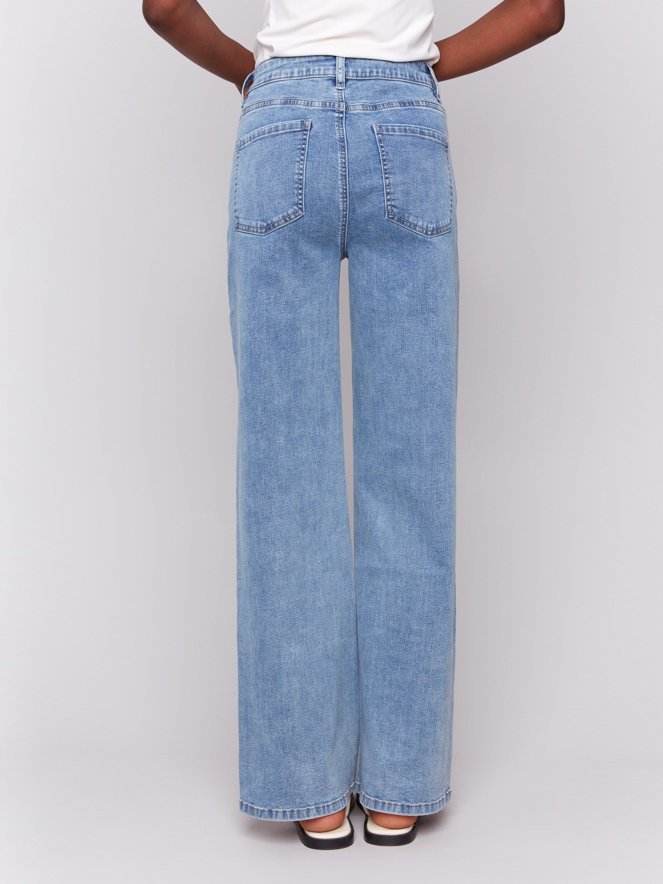 Light blue wide-leg jeans with five-pocket design featuring a button closure and relaxed fit by Charlie B.