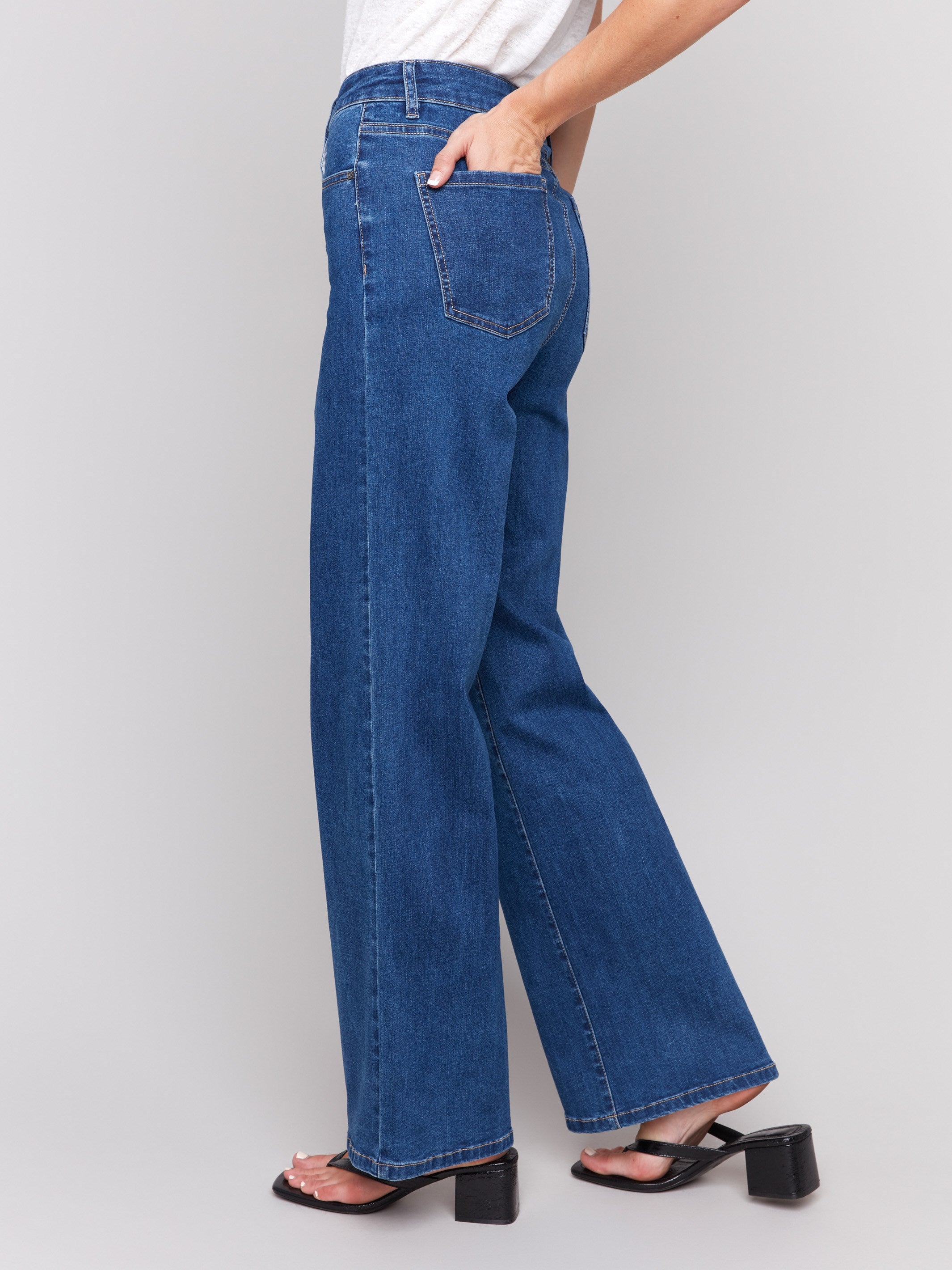 Indigo wide-leg jeans with five-pocket design featuring a button closure and relaxed fit by Charlie B.