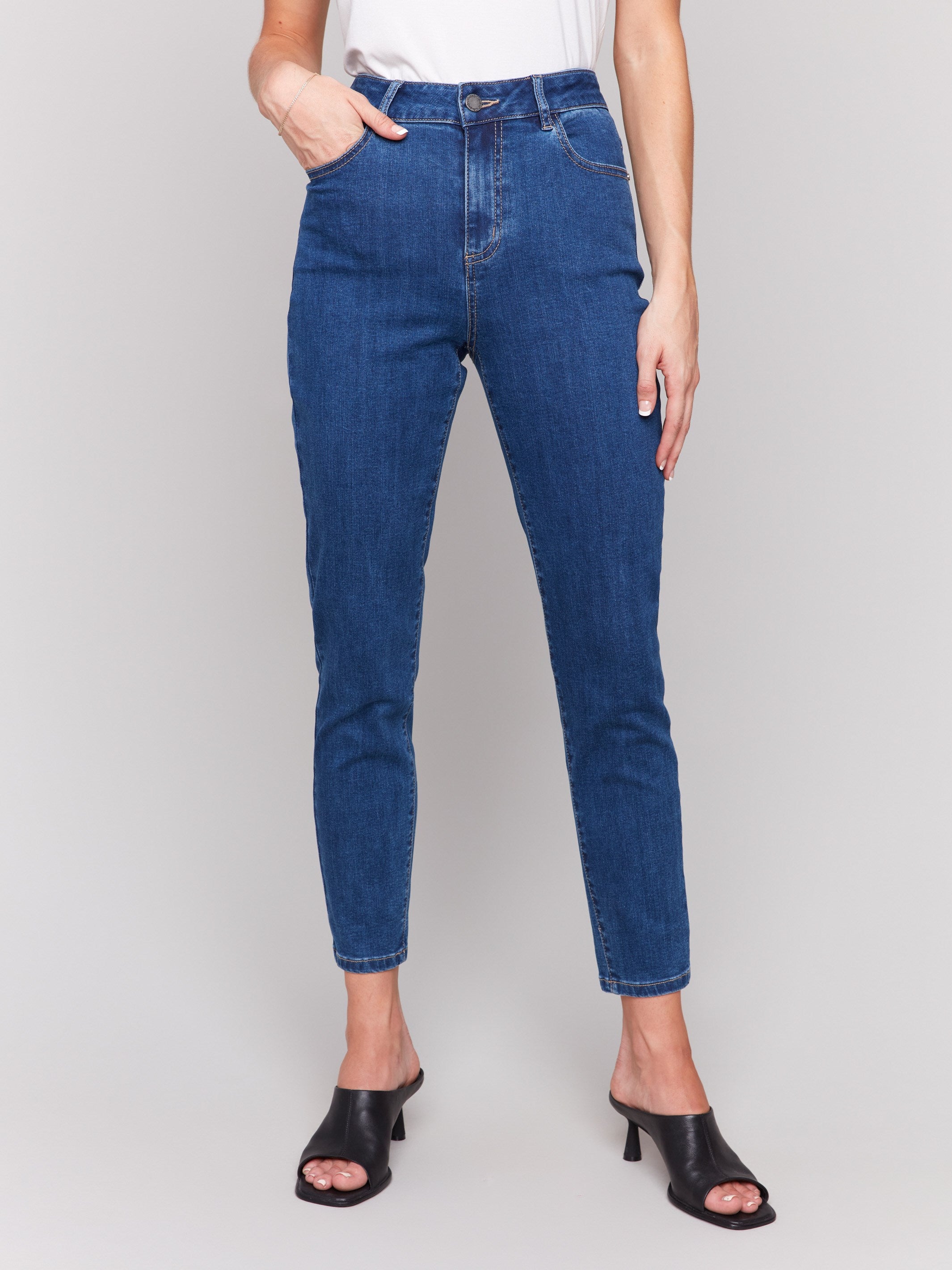 Indigo slim leg jeans with five-pocket design and button closure by Charlie B.