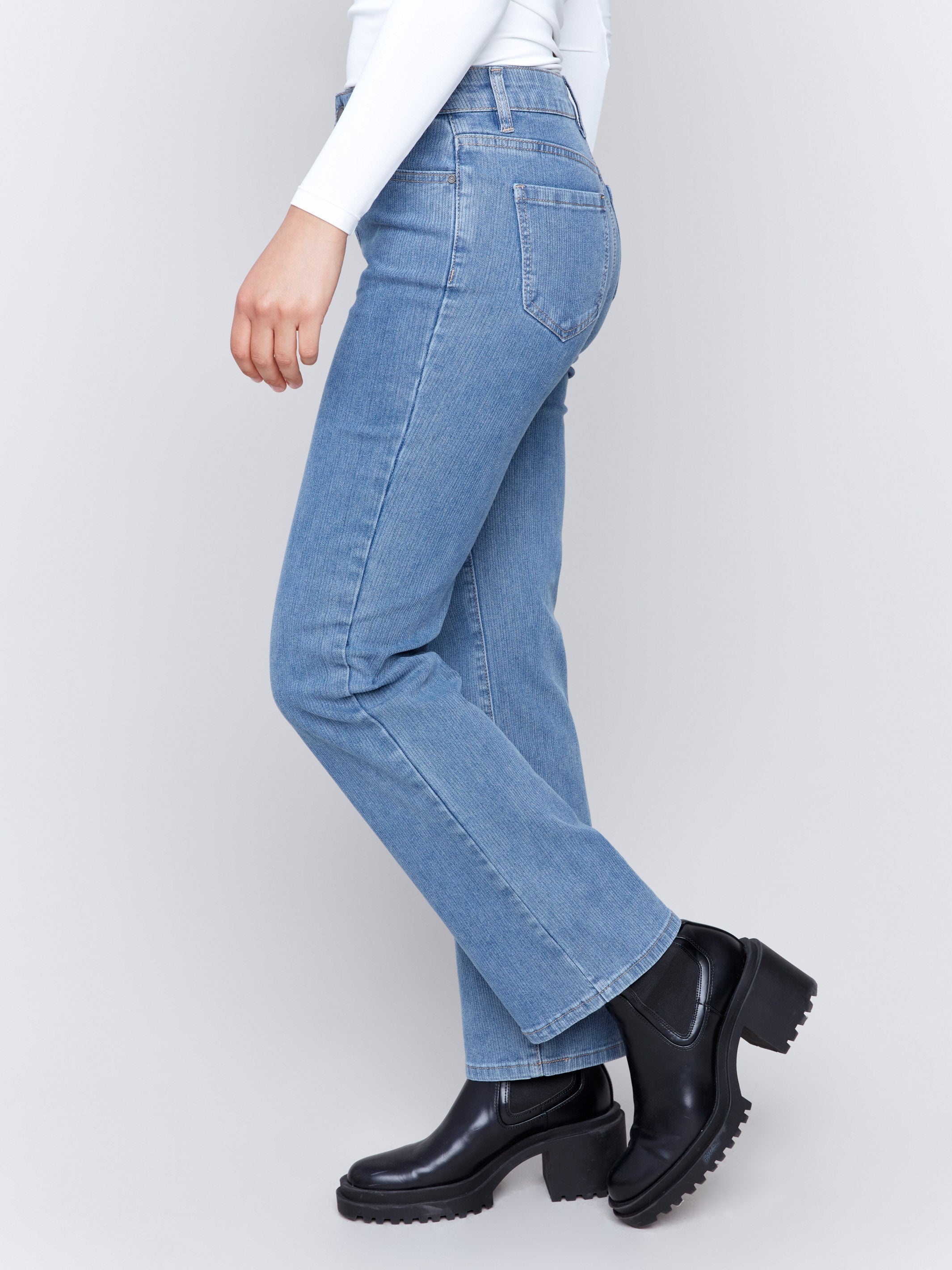 Light blue denim corduroy straight-leg pants with a five-pocket design and classic button closure by Charlie B.