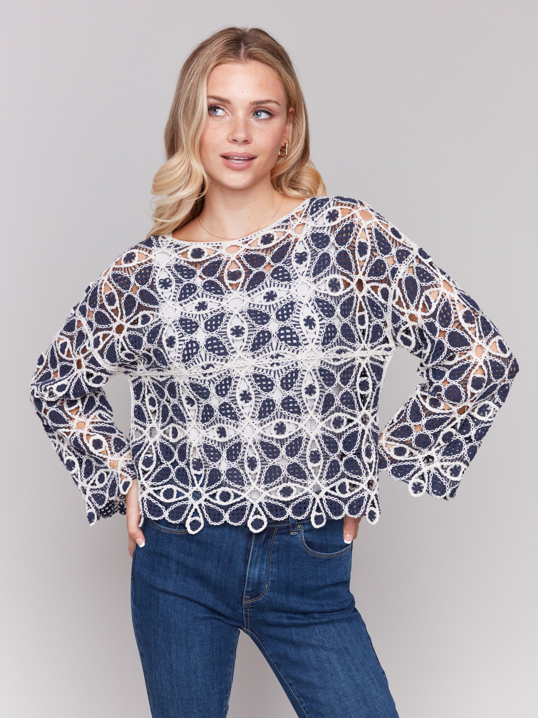 Elegant geometric pattern on a blue and white crochet top by Charlie B.