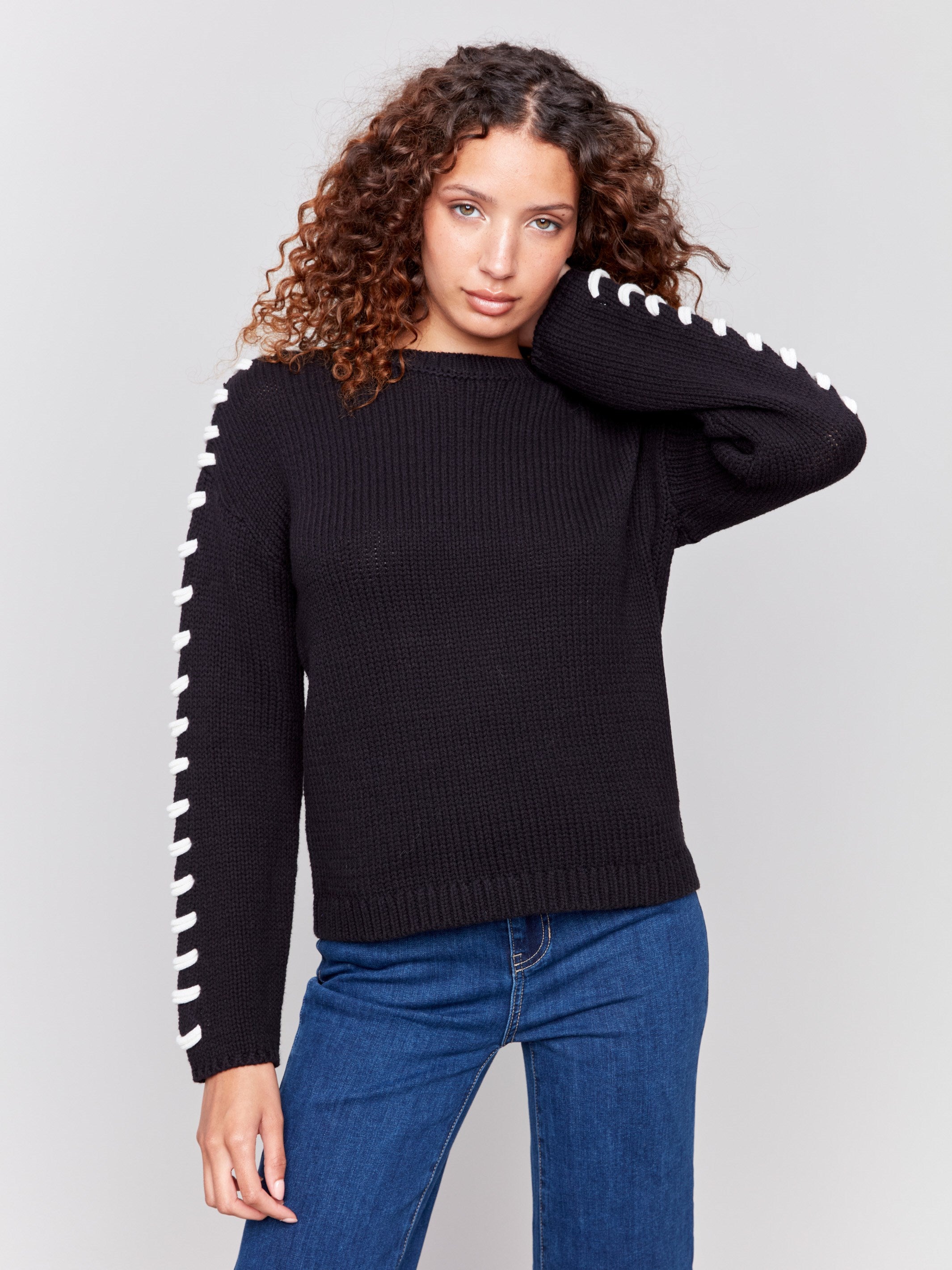 Black cotton blend sweater with white stitch detailing along the shoulders and a crew neckline by Charlie B.