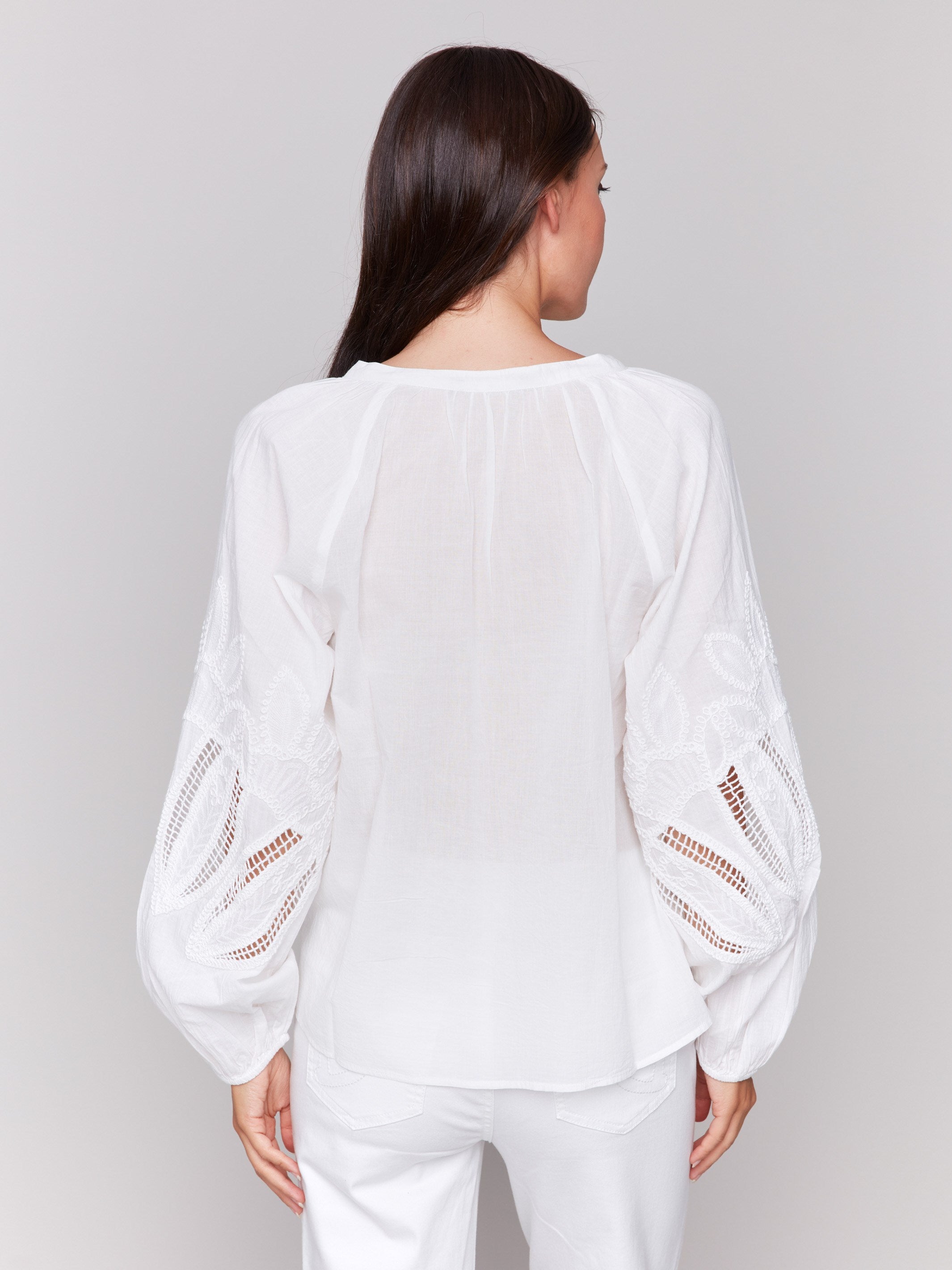 White blouse featuring artisan embroidery design by Charlie B.