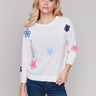 Sweater featuring hand-stitched flower patches on body by Charlie B.