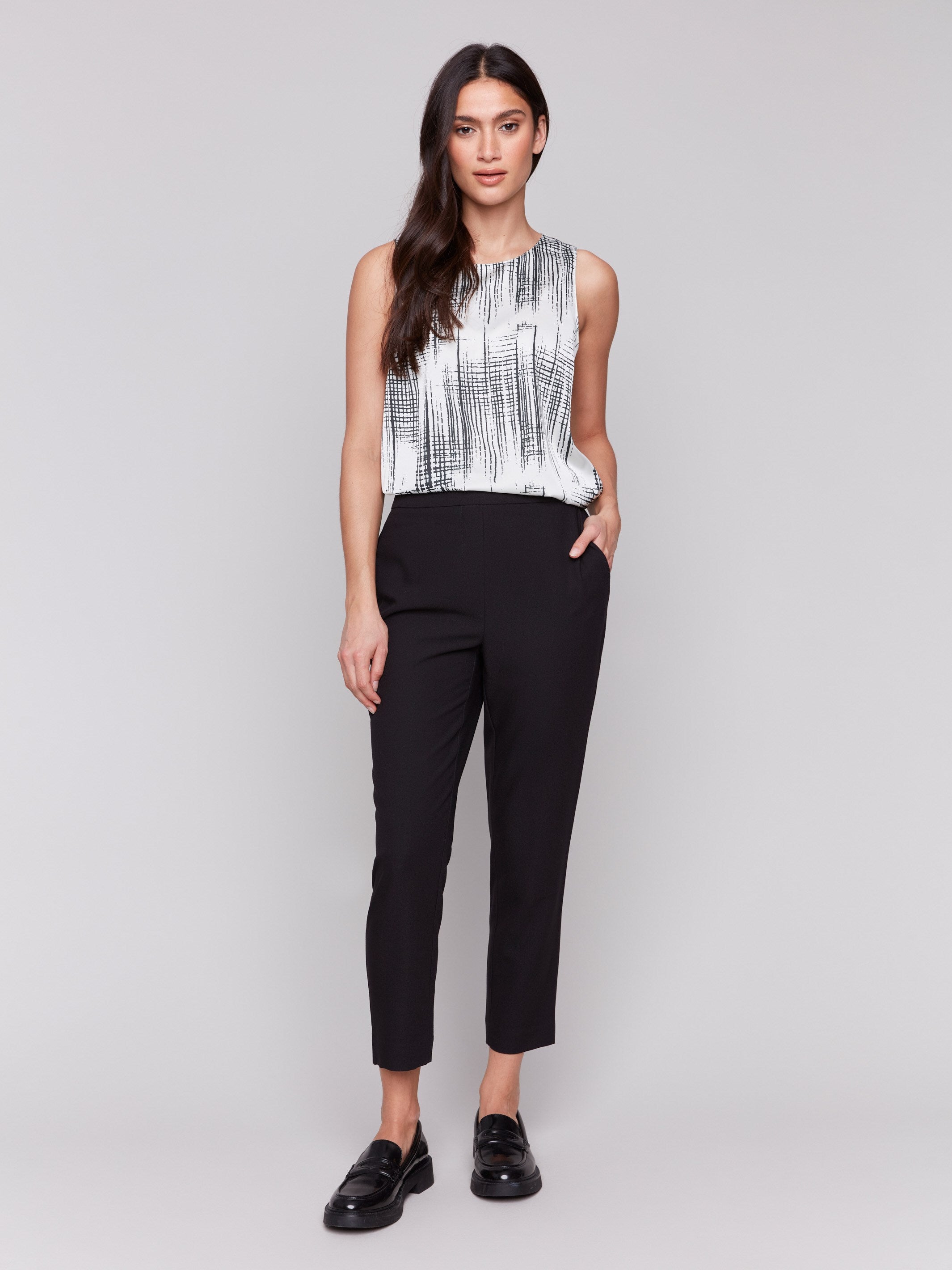 Black cropped crepe pants with side pockets and a slim leg design by Charlie B.