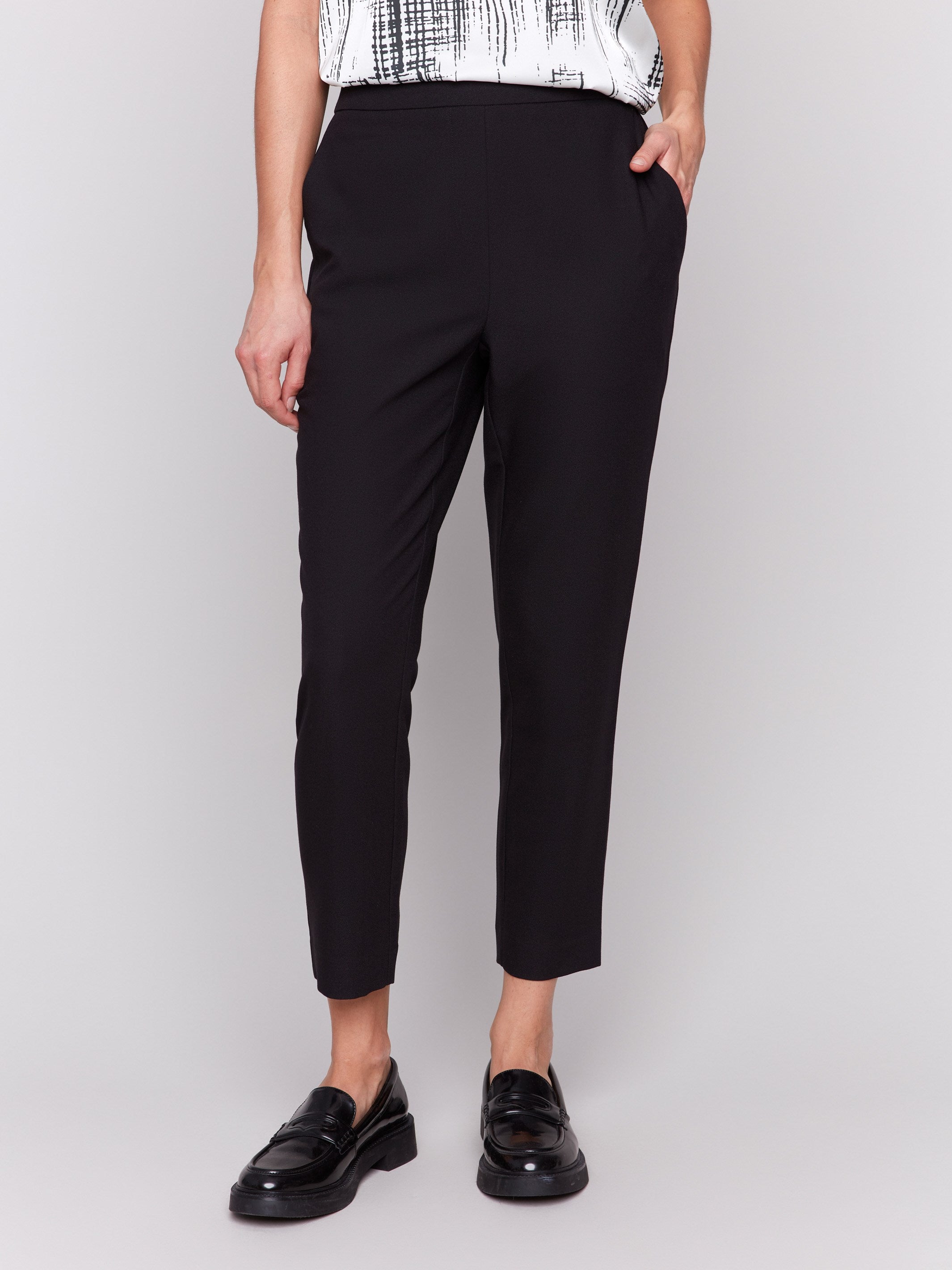 Black cropped crepe pants with side pockets and a slim leg design by Charlie B.