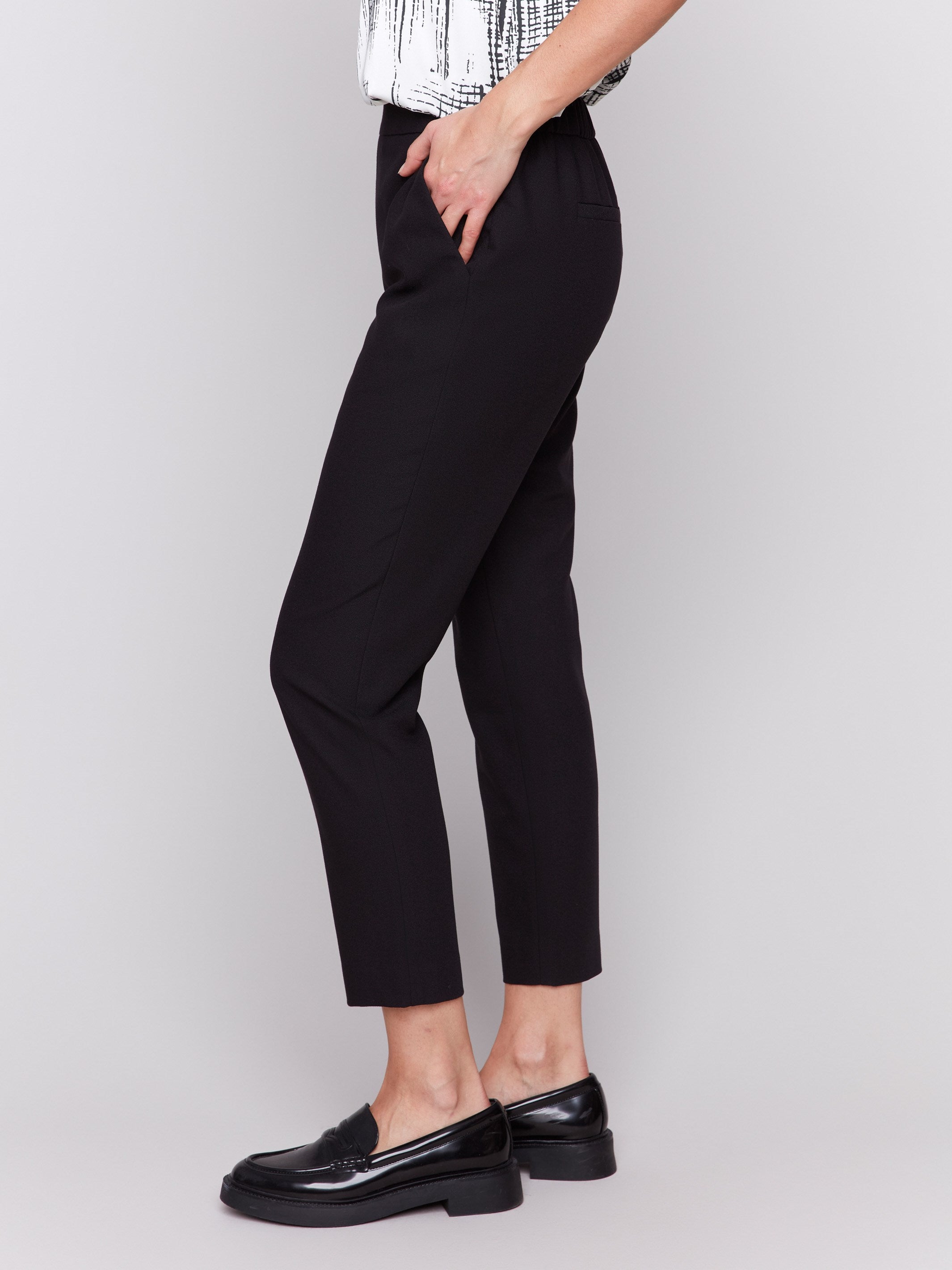 Black cropped crepe pants with side pockets and a slim leg design by Charlie B.