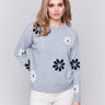 Light grey crew neck sweater with black and white floral prints featuring a drop shoulder design by Charlie B.