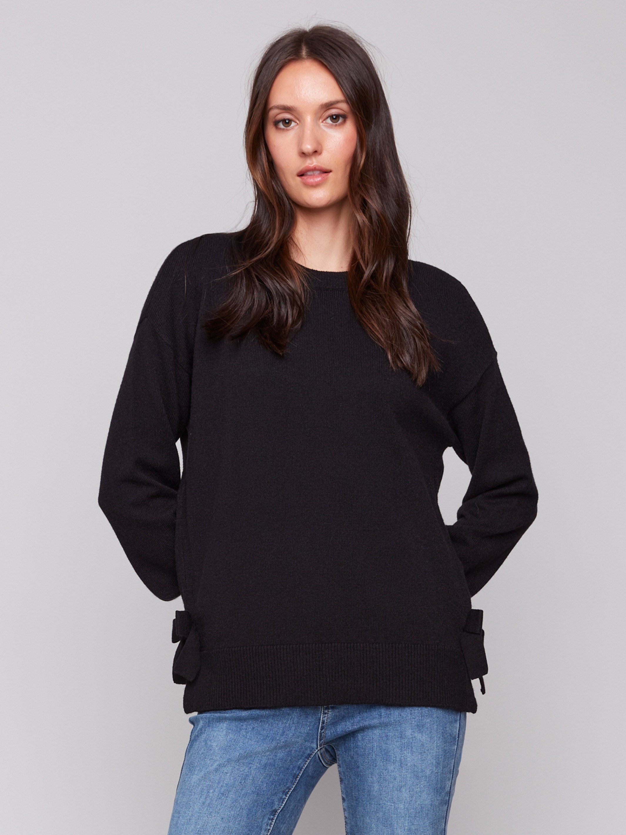 Black long-sleeve crew neck sweater with side bow details by Charlie B.