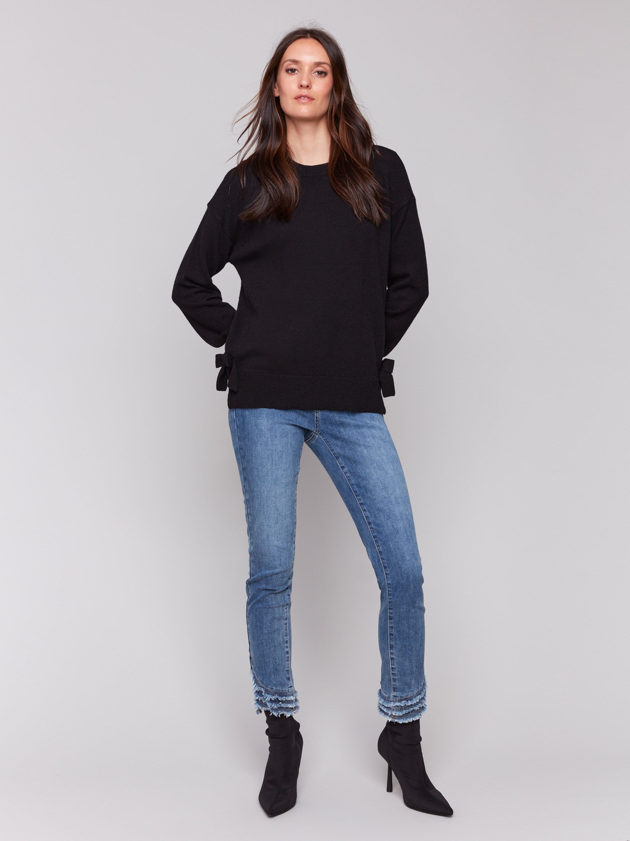 Black long-sleeve crew neck sweater with side bow details by Charlie B.