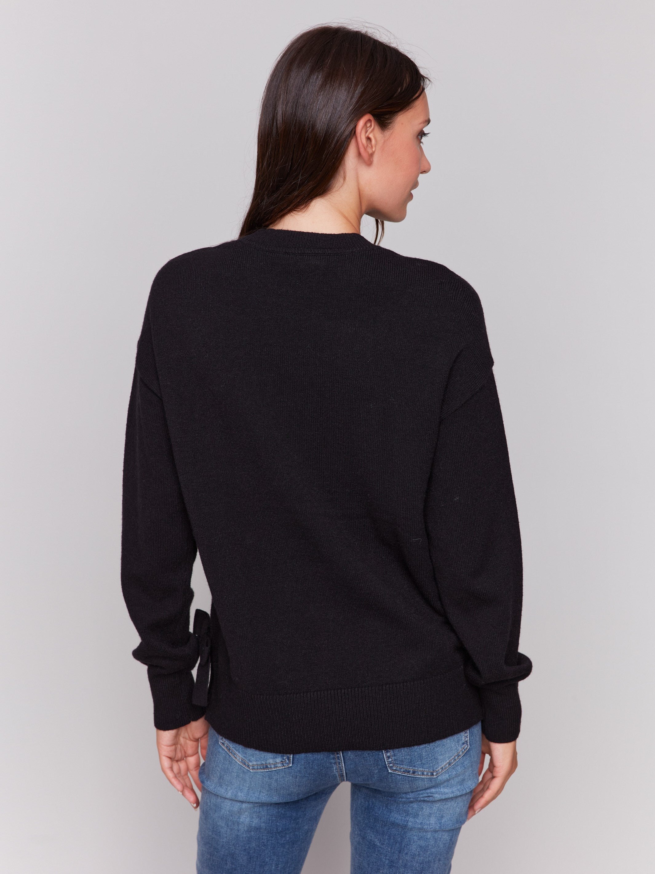 Black long-sleeve crew neck sweater with side bow details by Charlie B.