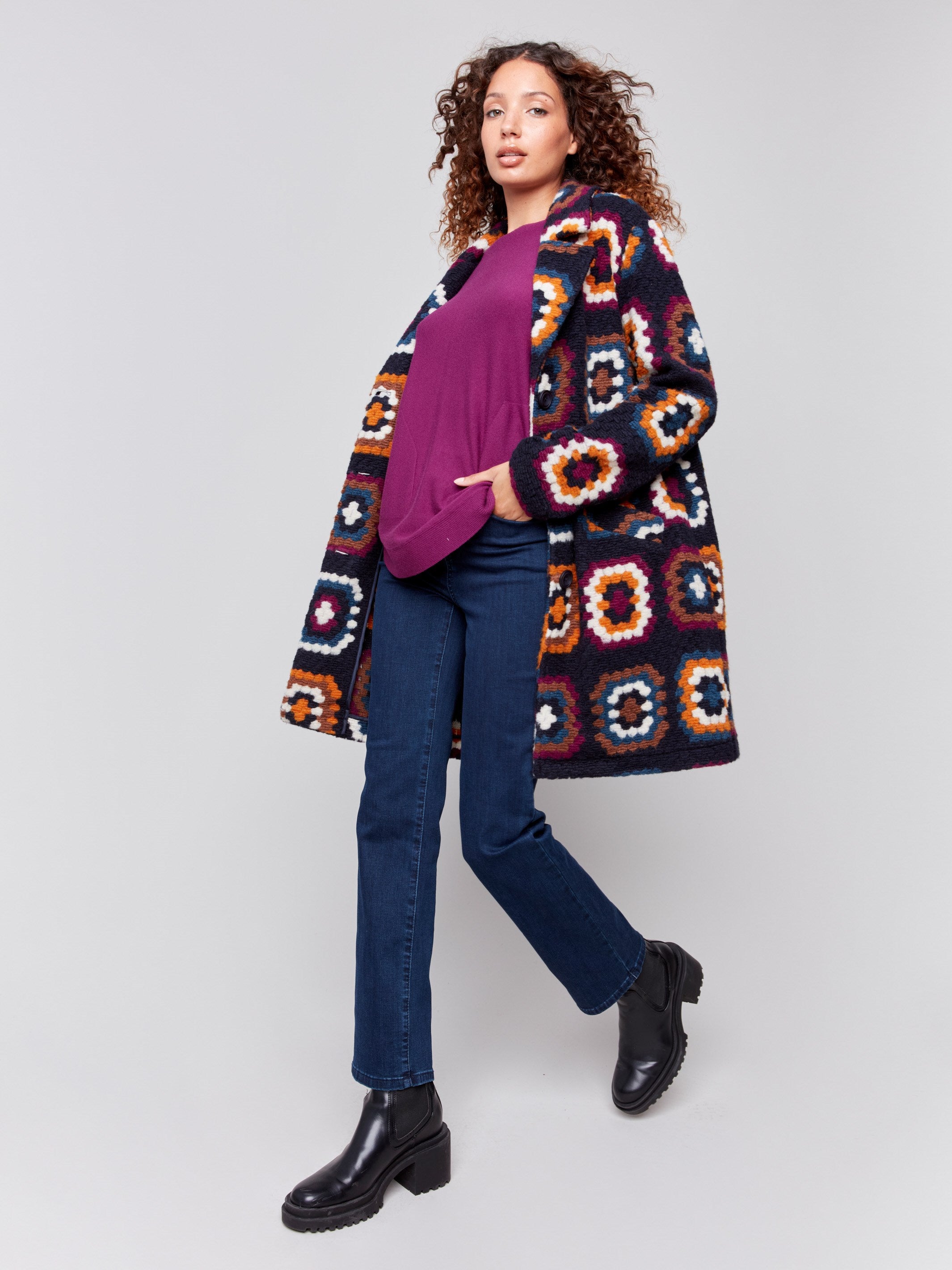 Navy blue crochet coat with colorful geometric patterns, featuring a front button closure and side welt pockets by Charlie B.