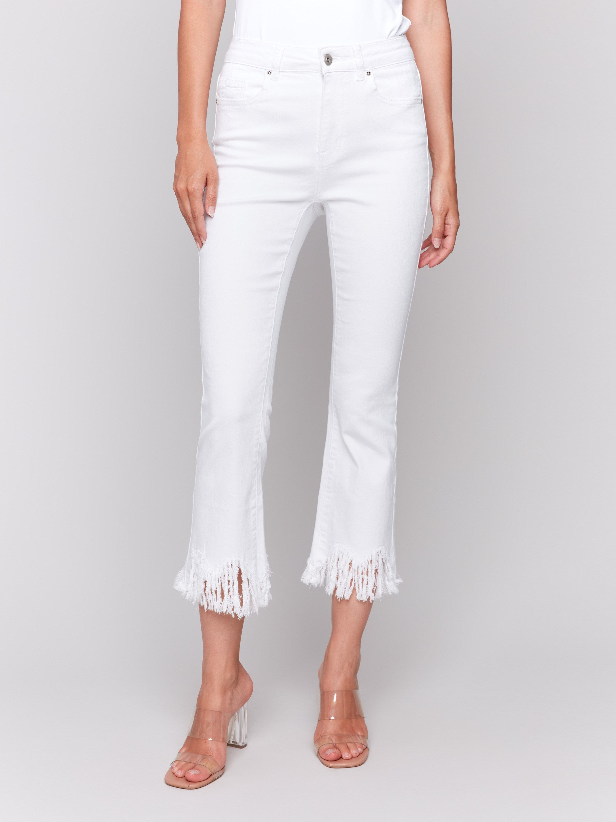 White cropped jeans with fringed hem, regular rise and bootcut leg design by Charlie B.