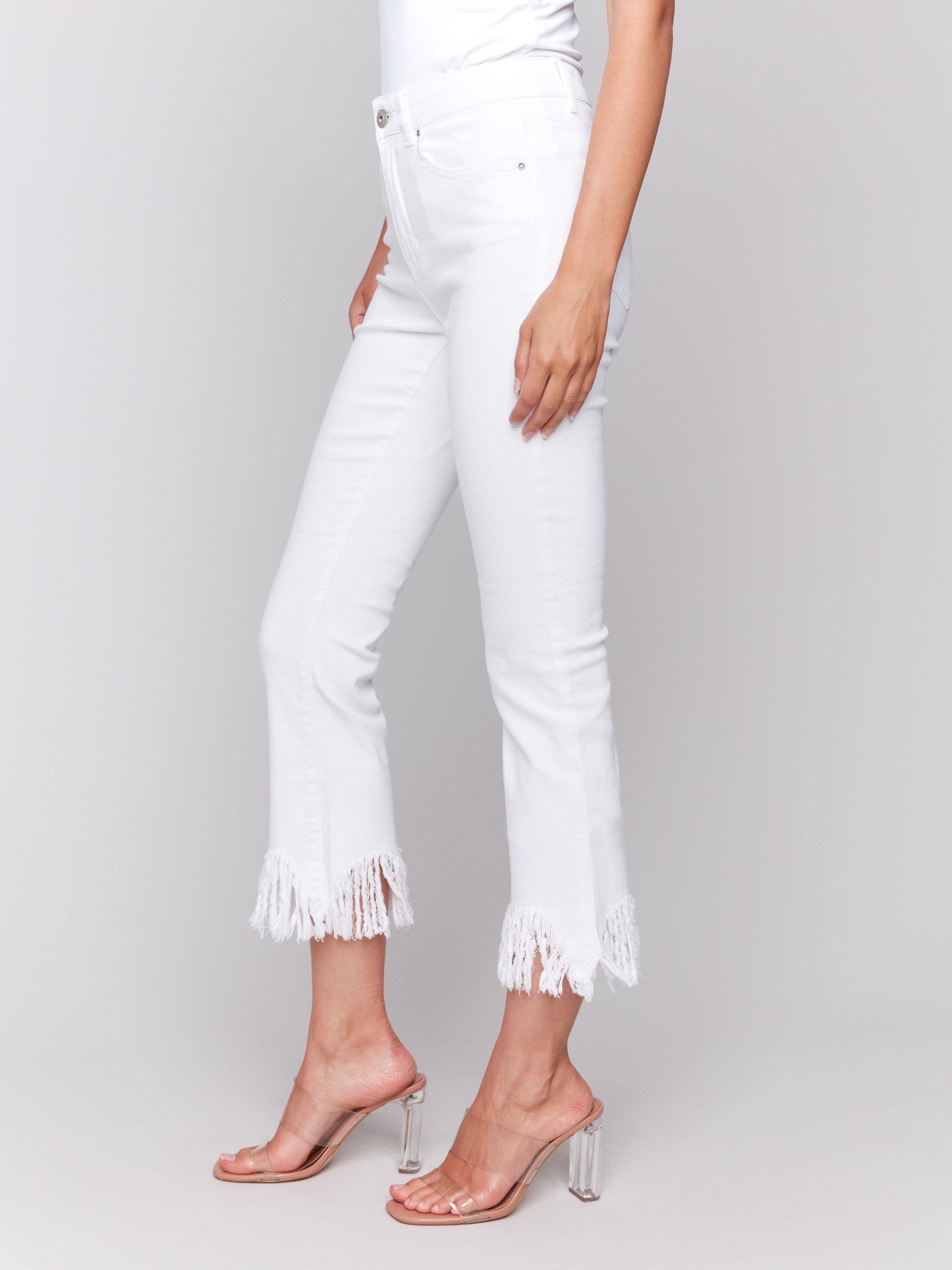 White cropped jeans with fringed hem, regular rise and bootcut leg design by Charlie B.