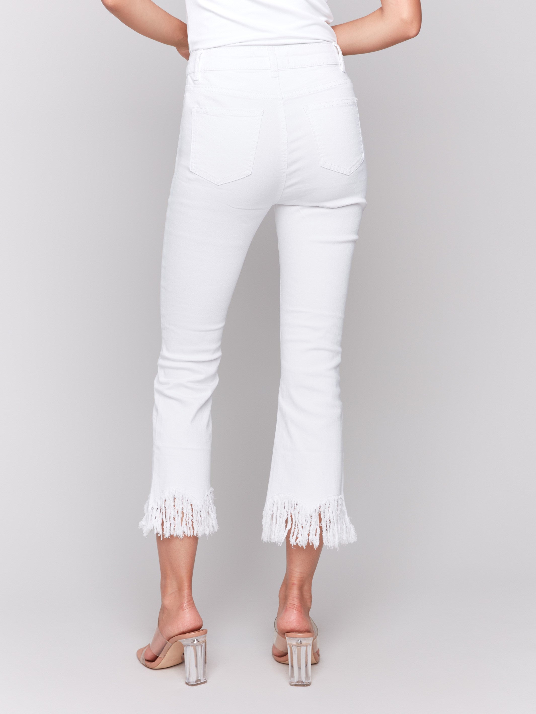 White cropped jeans with fringed hem, regular rise and bootcut leg design by Charlie B.