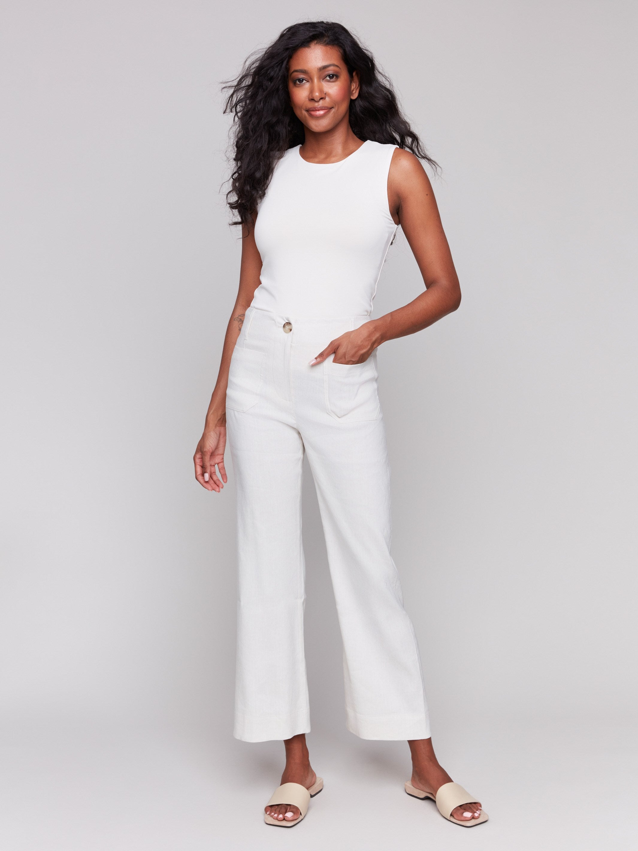 Natural linen blend pants with a cropped length and button closure by Charlie B.