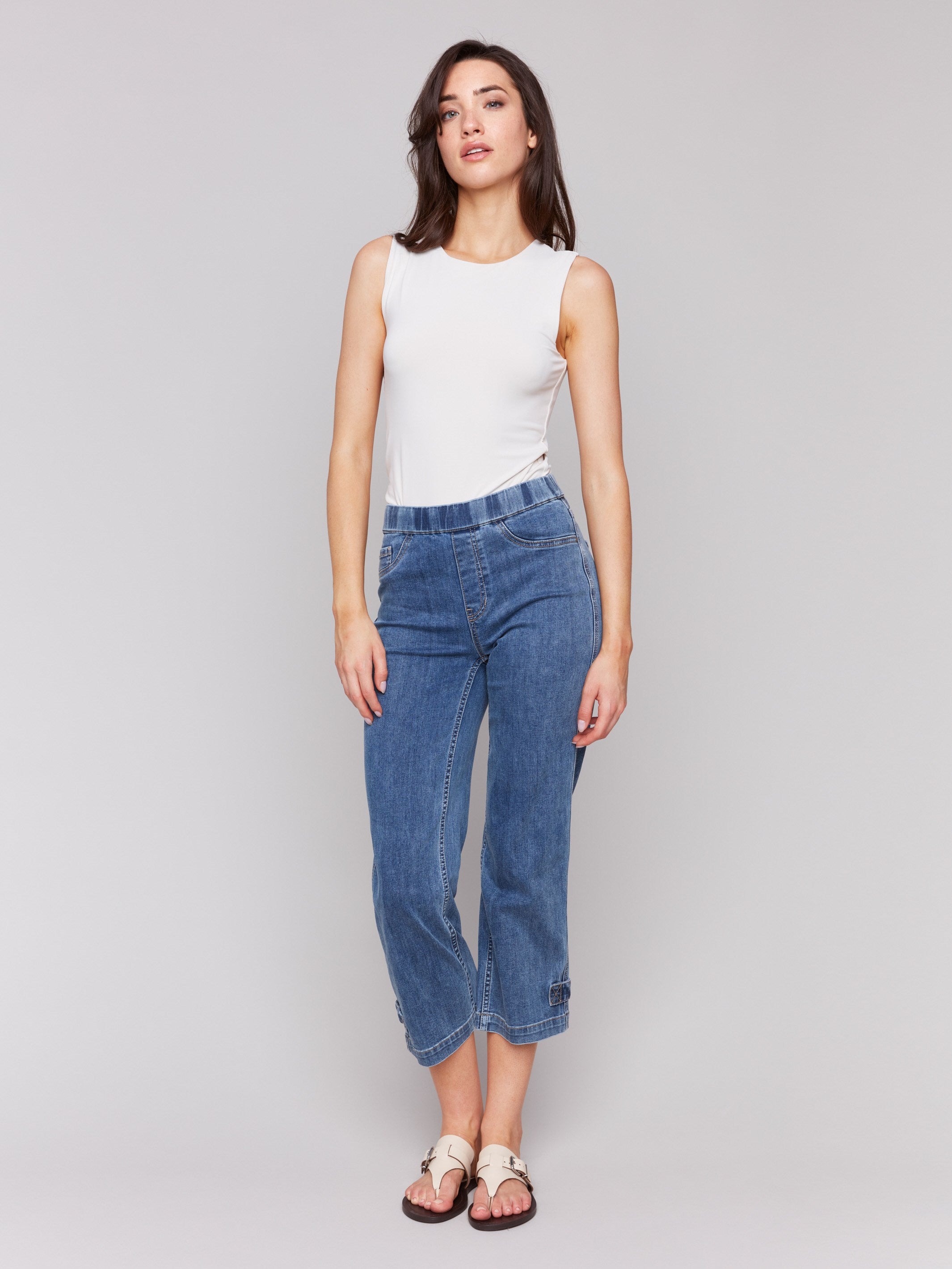 Medium blue jeans with buttoned hem tab detail, made from stretch denim material by Charlie B.