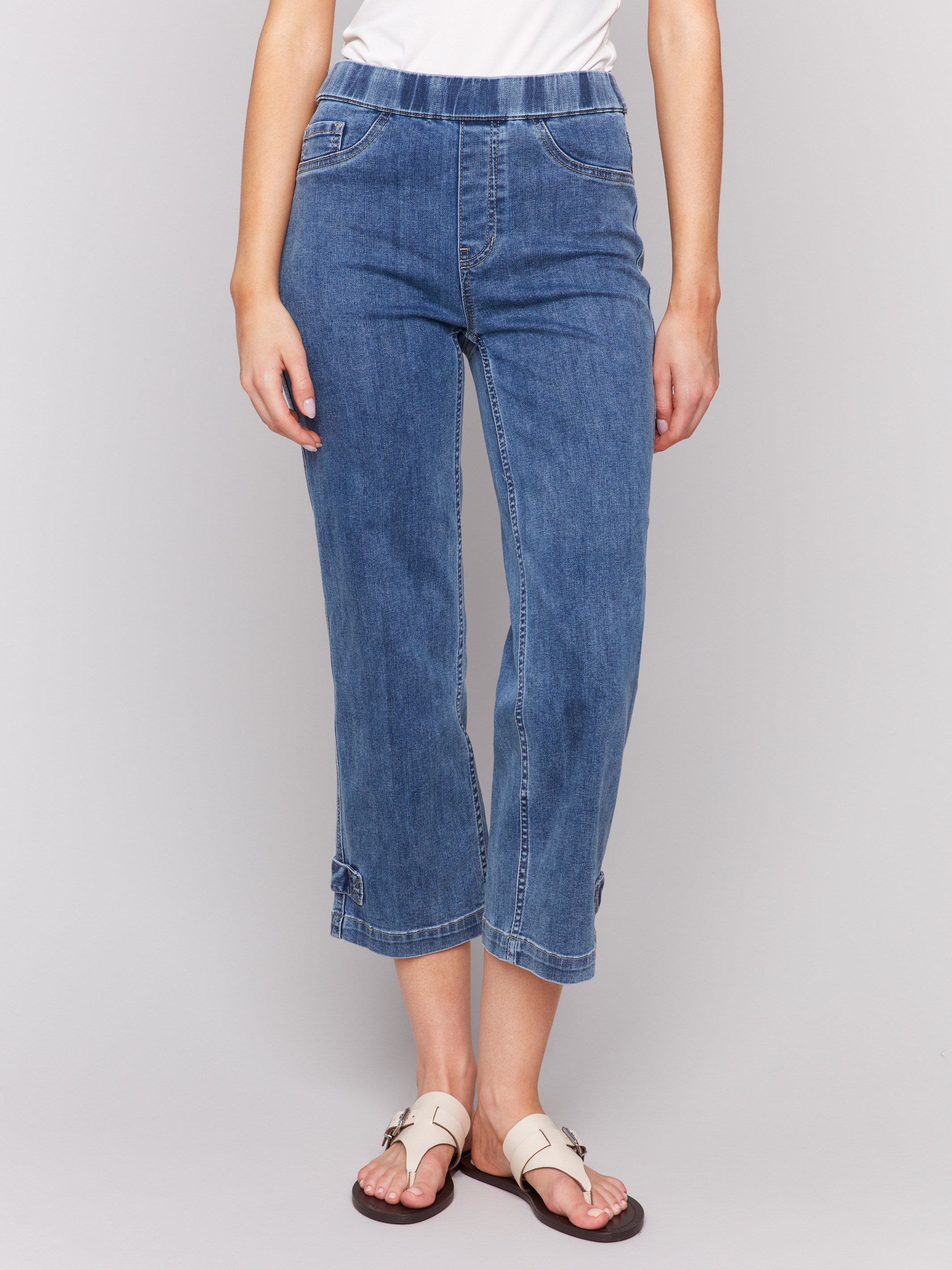 Cropped length jeans in medium blue, featuring two faux front pockets and regular rise waist by Charlie B.