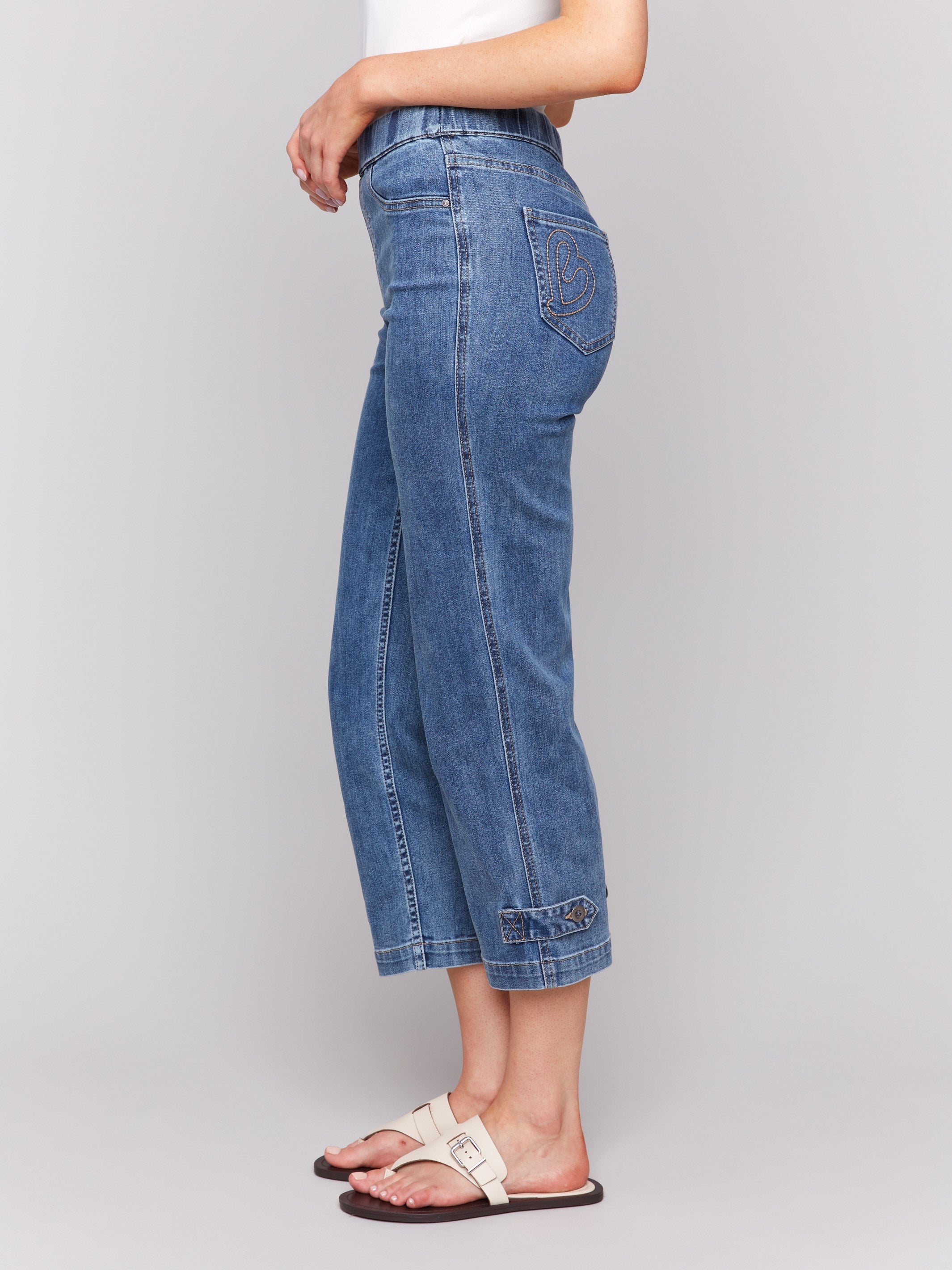 Pull-on style jeans with snug elasticized waistband and back pockets, crafted in medium blue by Charlie B.