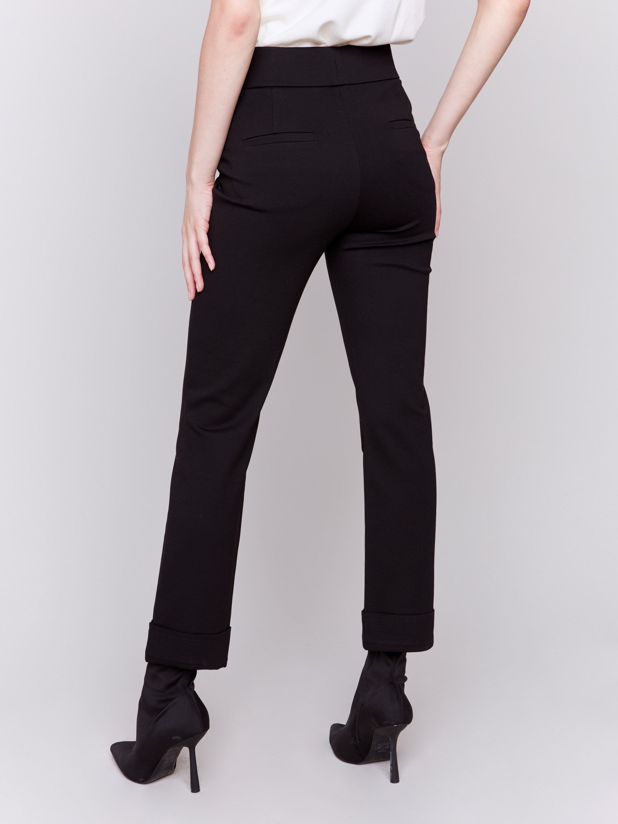 Black cuffed ponte pants featuring a straight leg fit, with welt pockets and a cuffed hem by Charlie B.