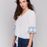 White cotton blouse with V-neck and blue embroidery by Charlie B.