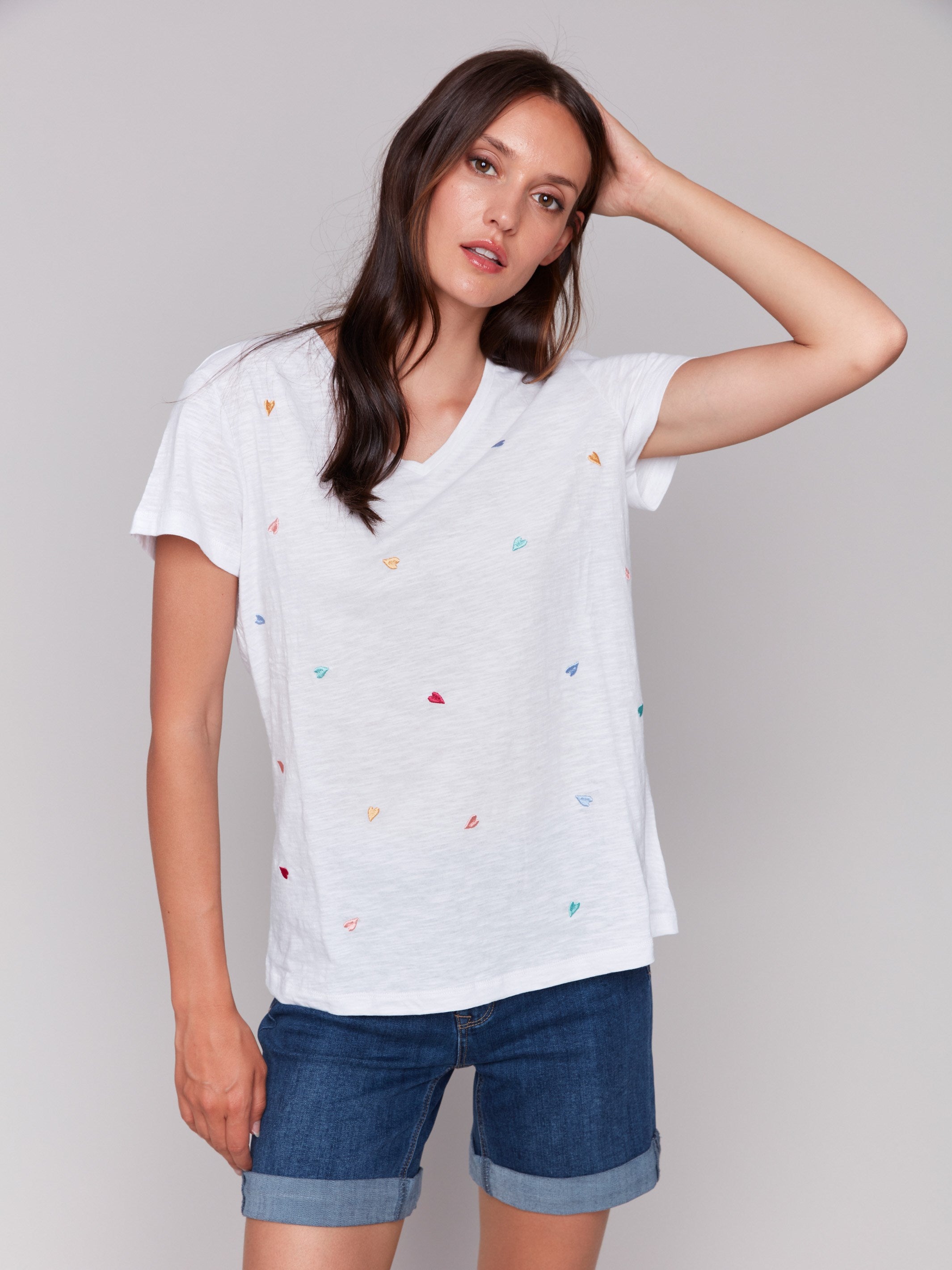 White V-neck t-shirt with colorful heart embroidery, featuring short sleeves by Charlie B.