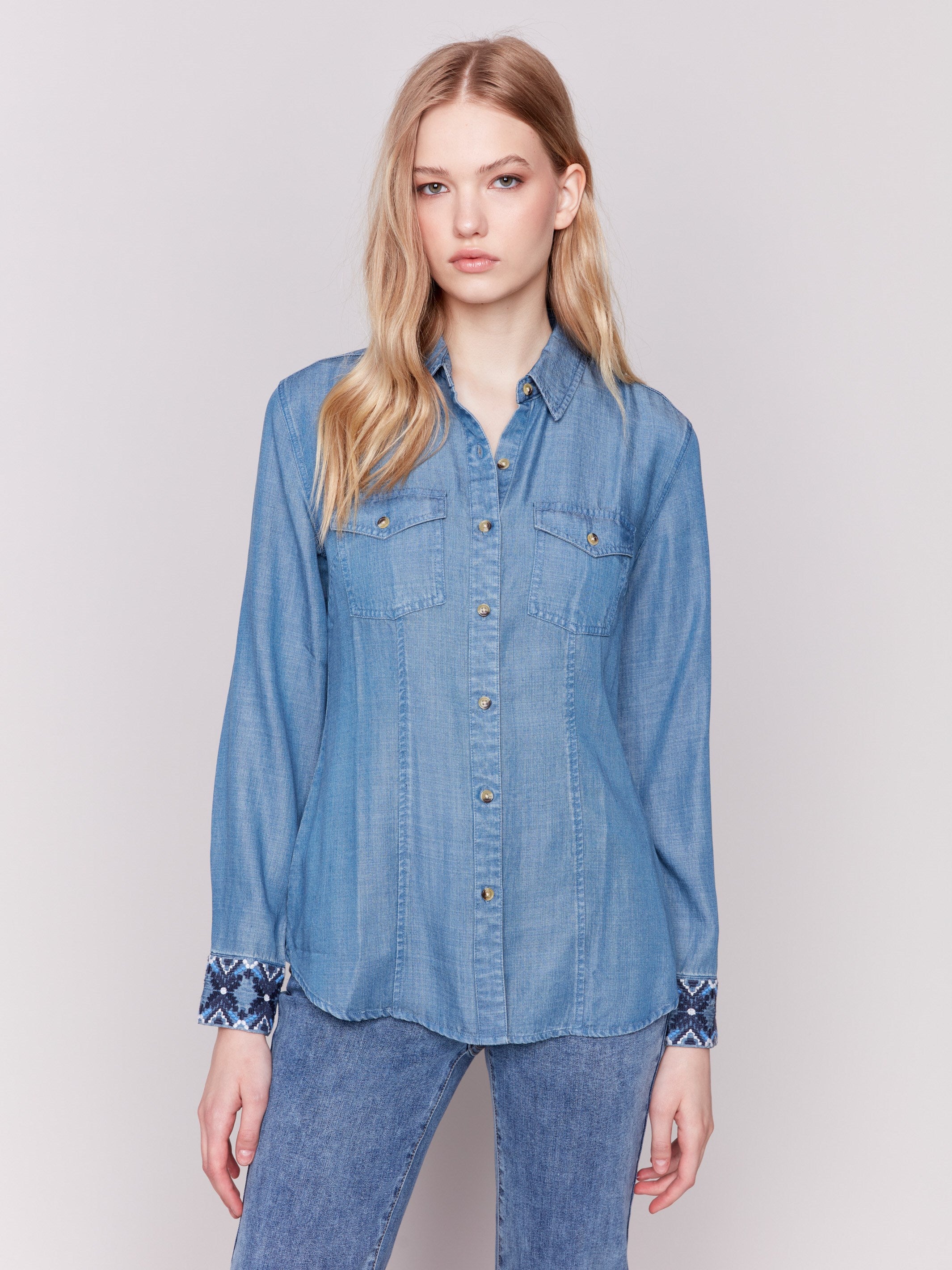 Denim-colored long sleeve Tencel shirt featuring embroidered cuffs and front button closure by Charlie B.