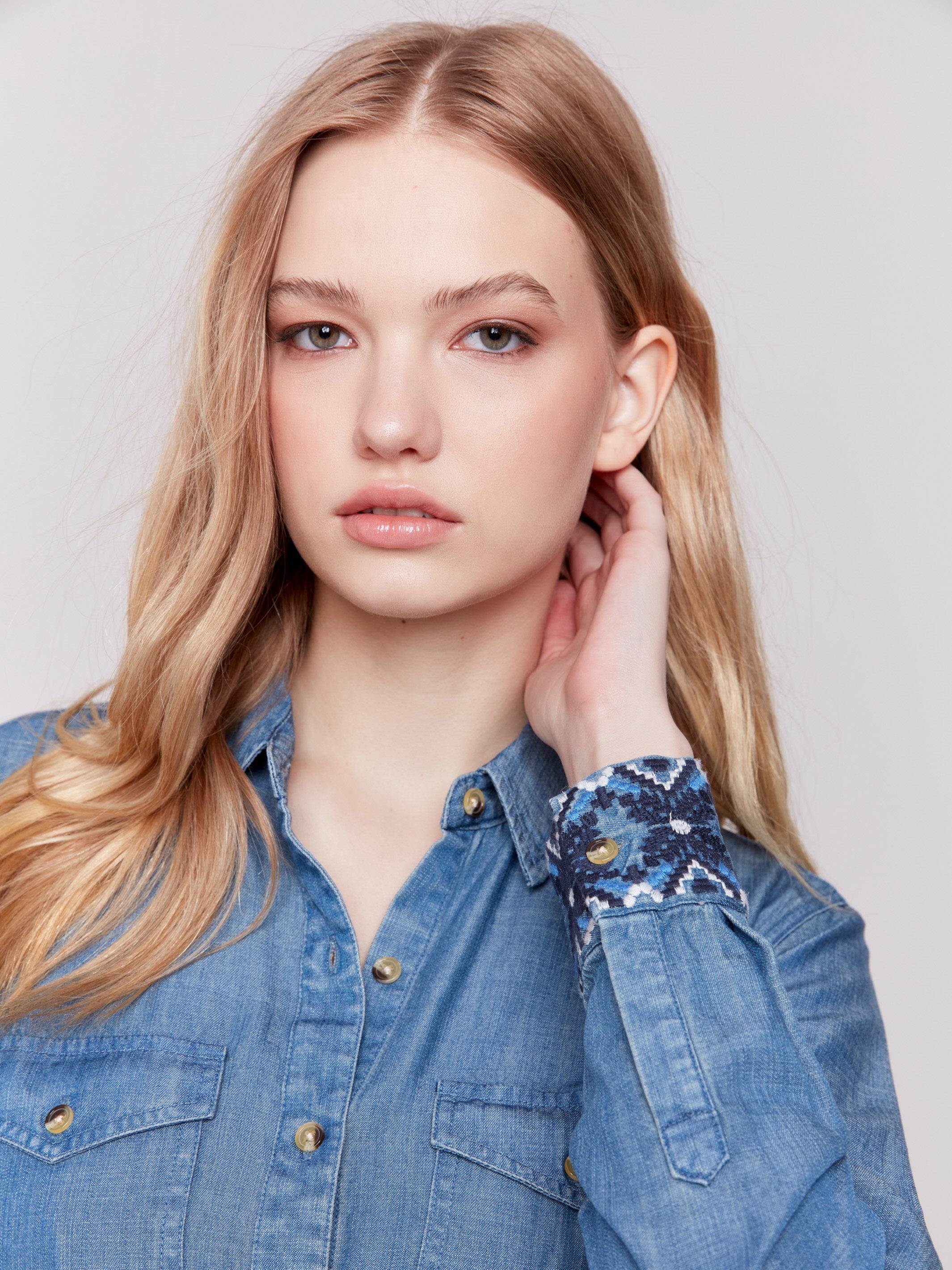 Denim-colored long sleeve Tencel shirt featuring embroidered cuffs and front button closure by Charlie B.