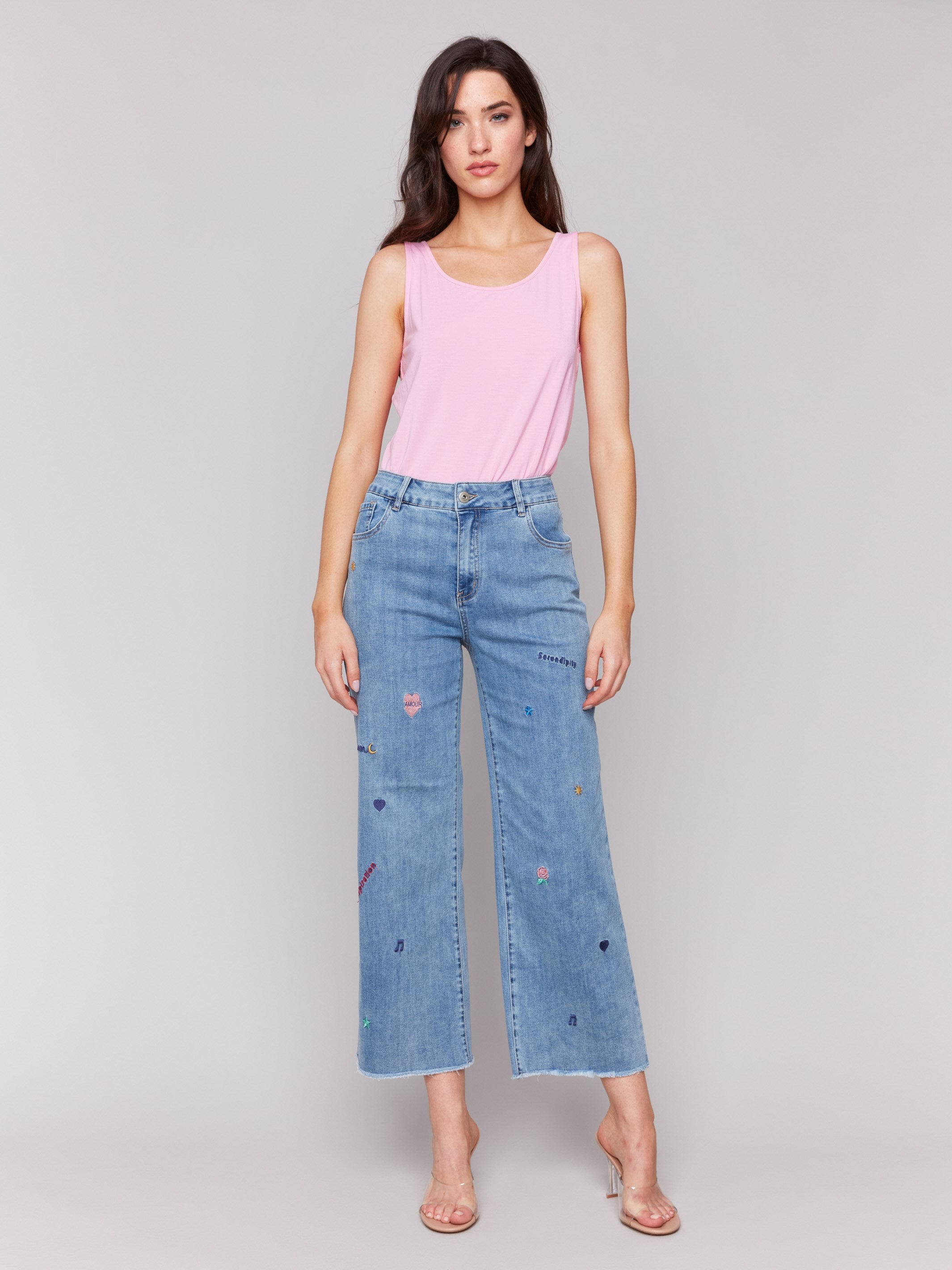 Medium blue flare leg jeans with embroidery and frayed hem by Charlie B.