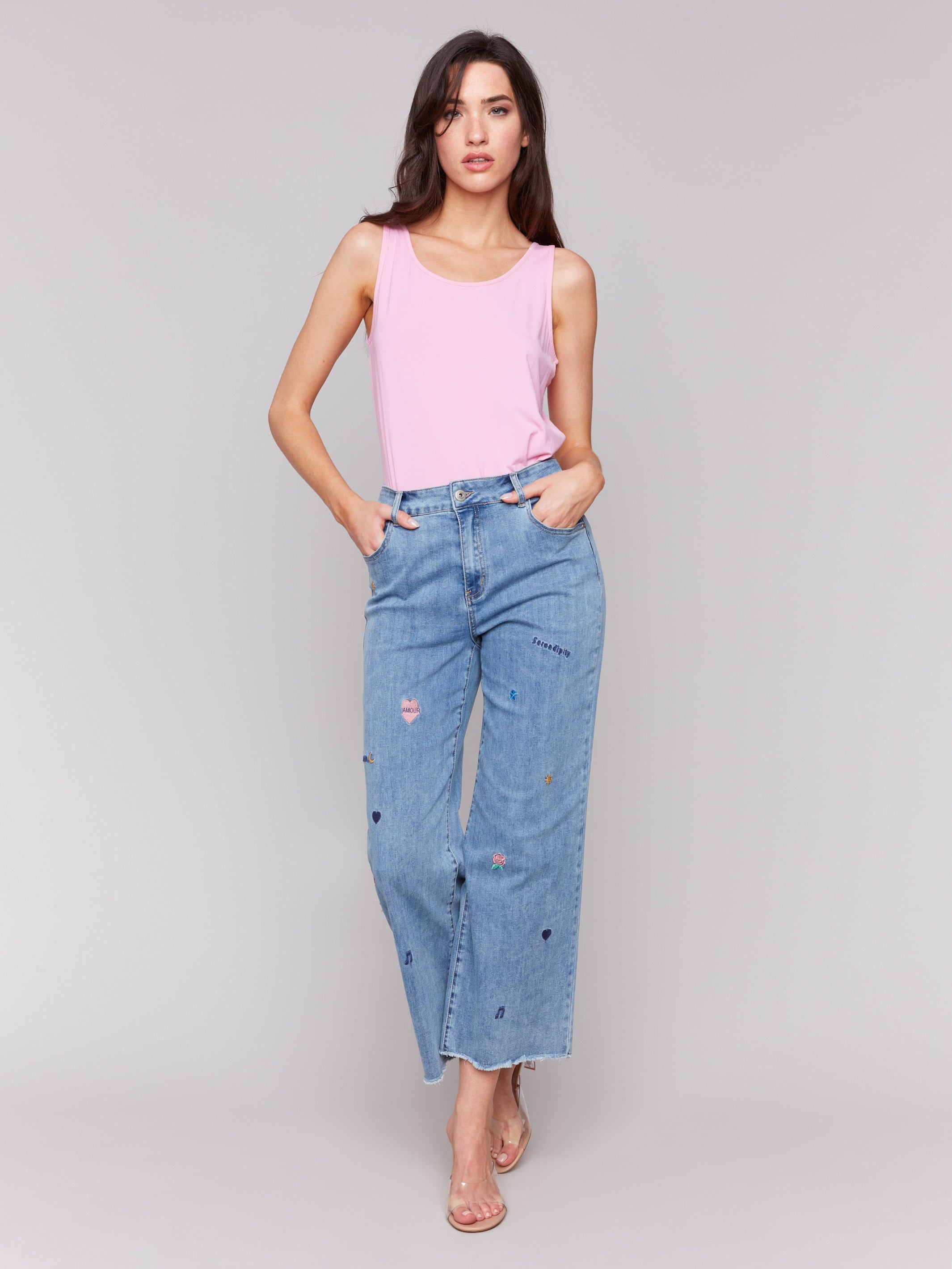 Medium blue flare leg jeans with embroidery and frayed hem by Charlie B.