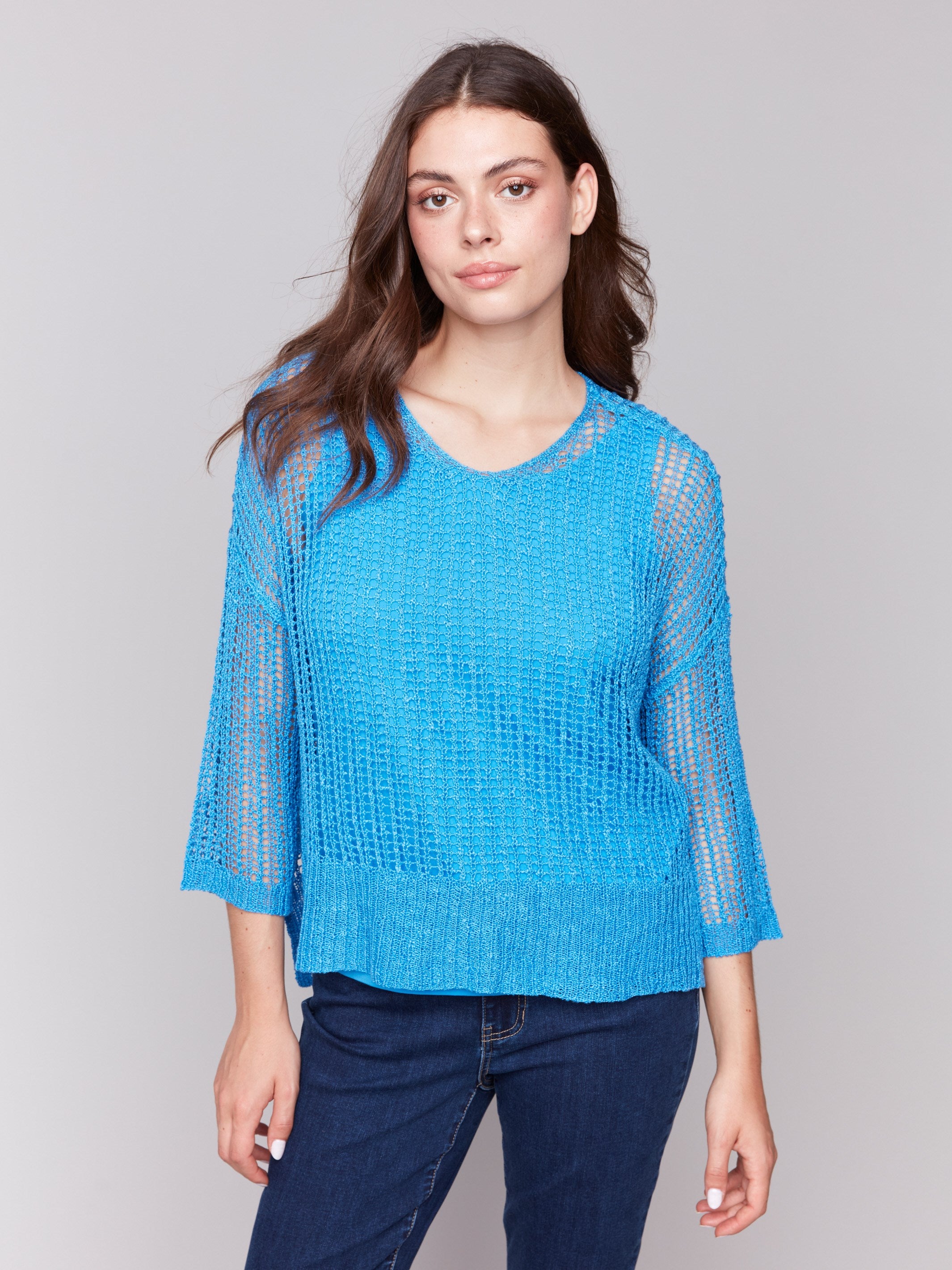 Lagoon blue sweater with a relaxed V-neck design by Charlie B.