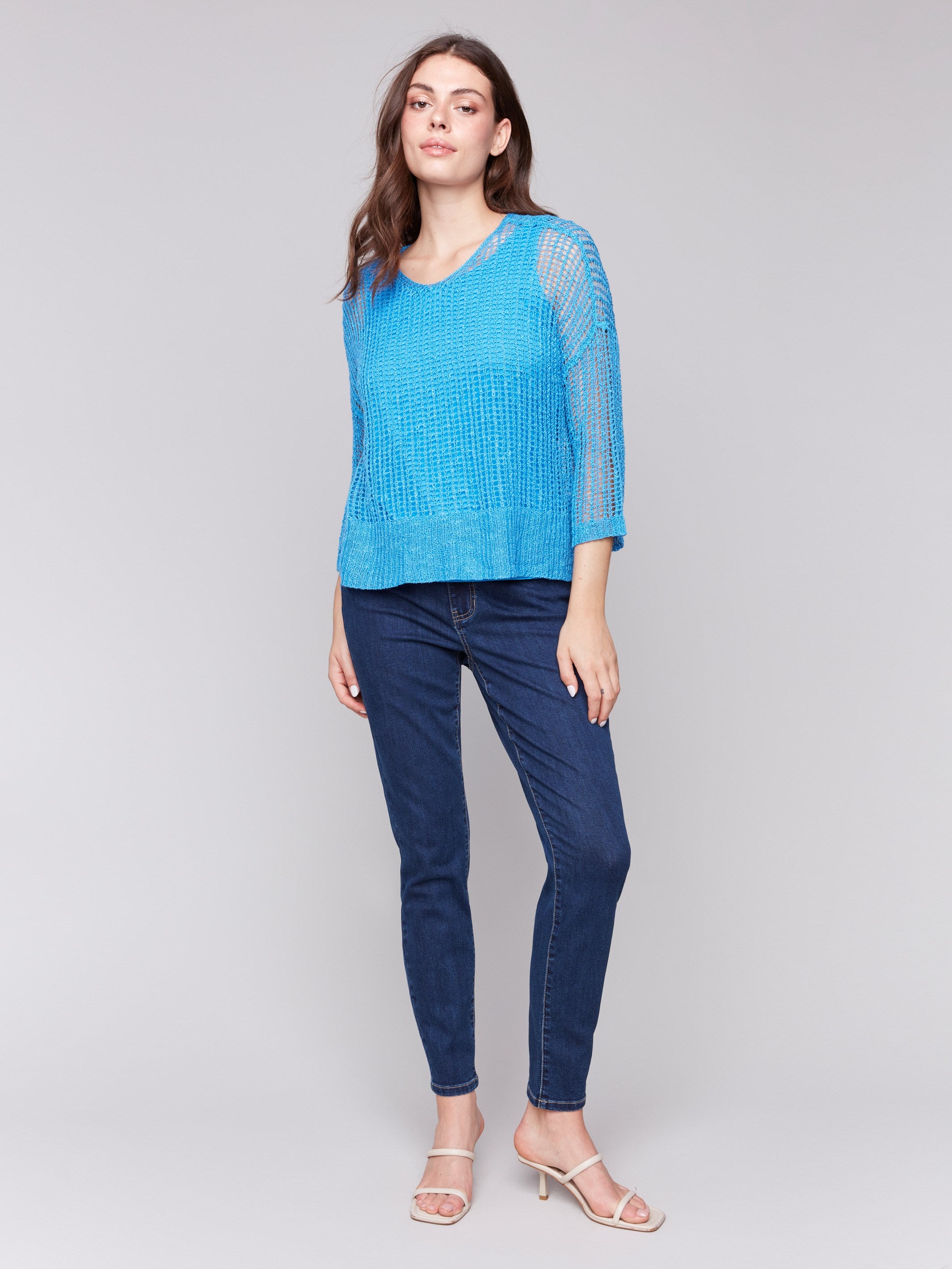 Fishnet crochet sweater featuring drop shoulder style in lagoon blue by Charlie B.