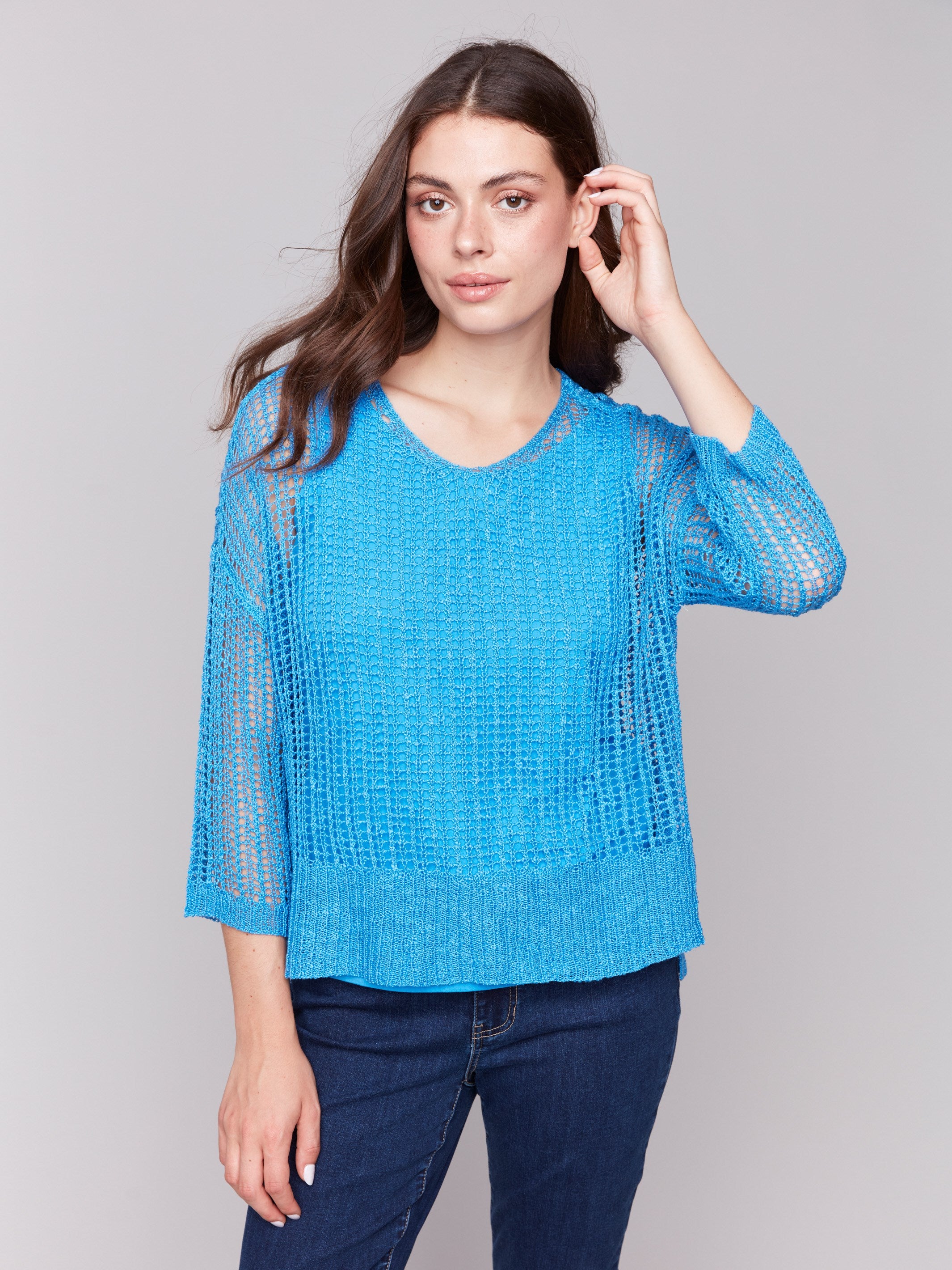 Loose fit fishnet crochet sweater in vibrant lagoon hue by Charlie B.