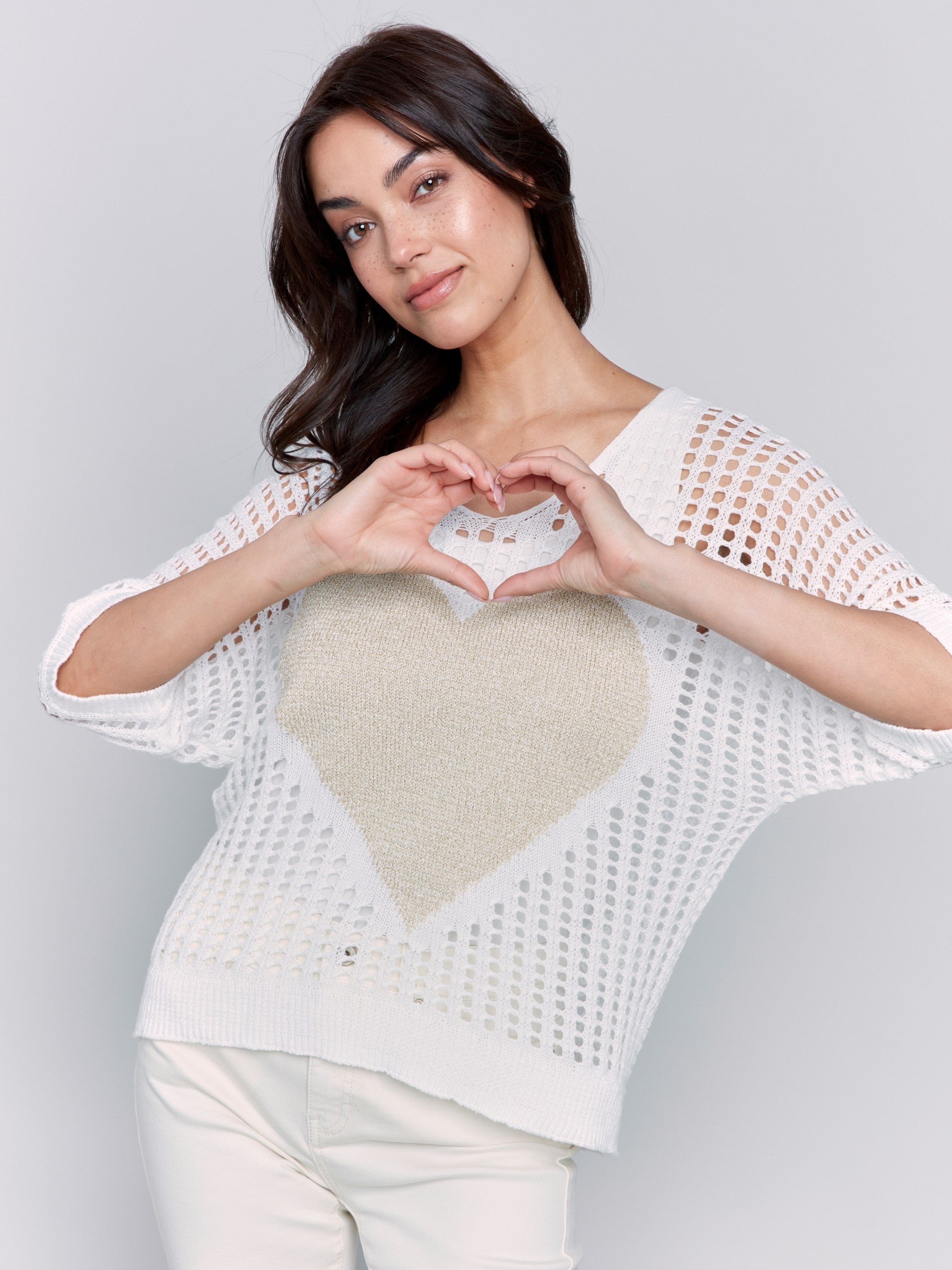 White fishnet V-neck sweater with a gold heart design and 3/4 dolman sleeves by Charlie B.