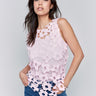 Pink top with a crew neckline featuring a floral crochet by Charlie B.