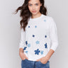 Cotton sweater with crew neckline and blue floral denim patches by Charlie B.