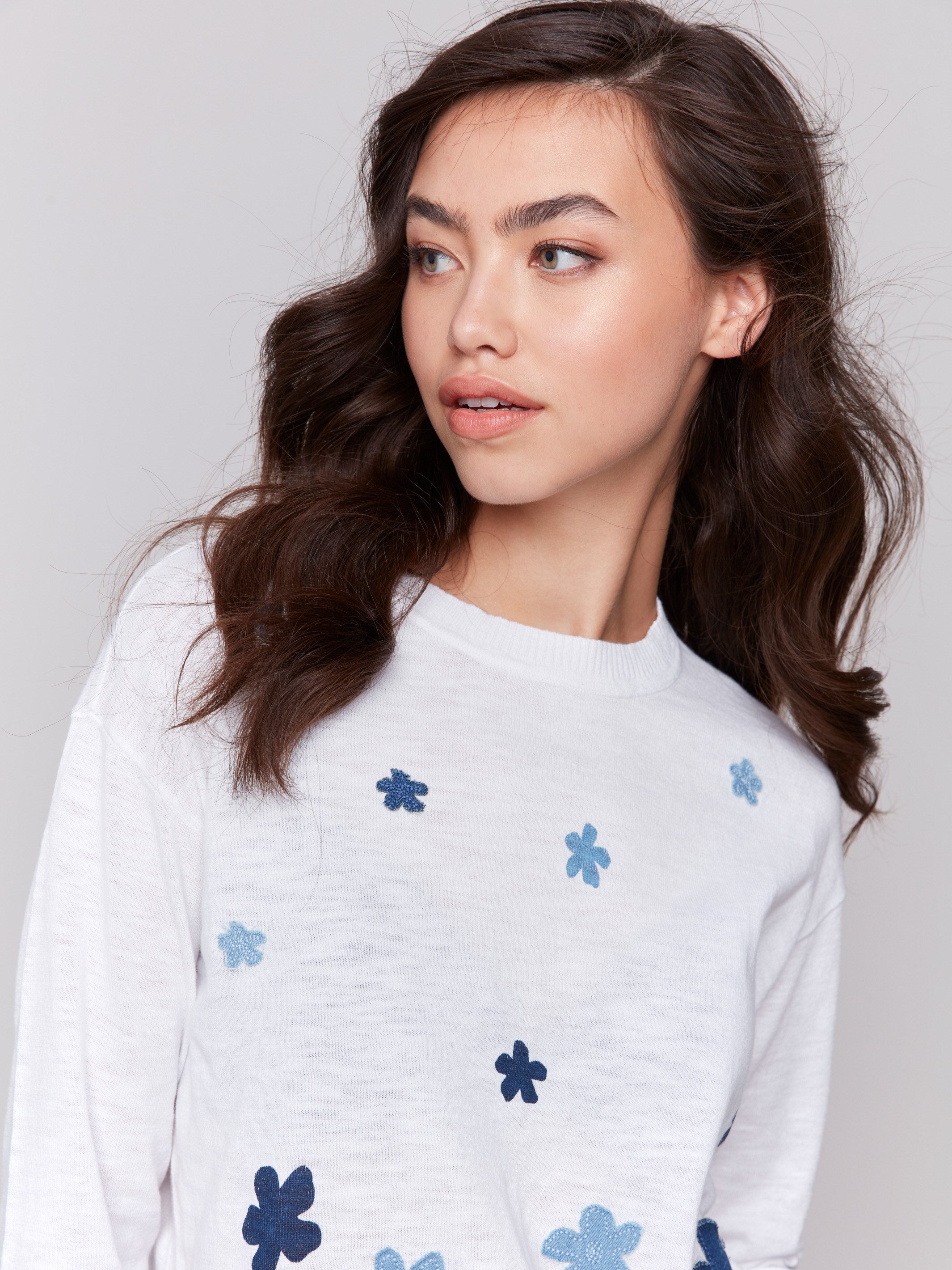 Sweater featuring 3/4 sleeves and floral denim accents by Charlie B.