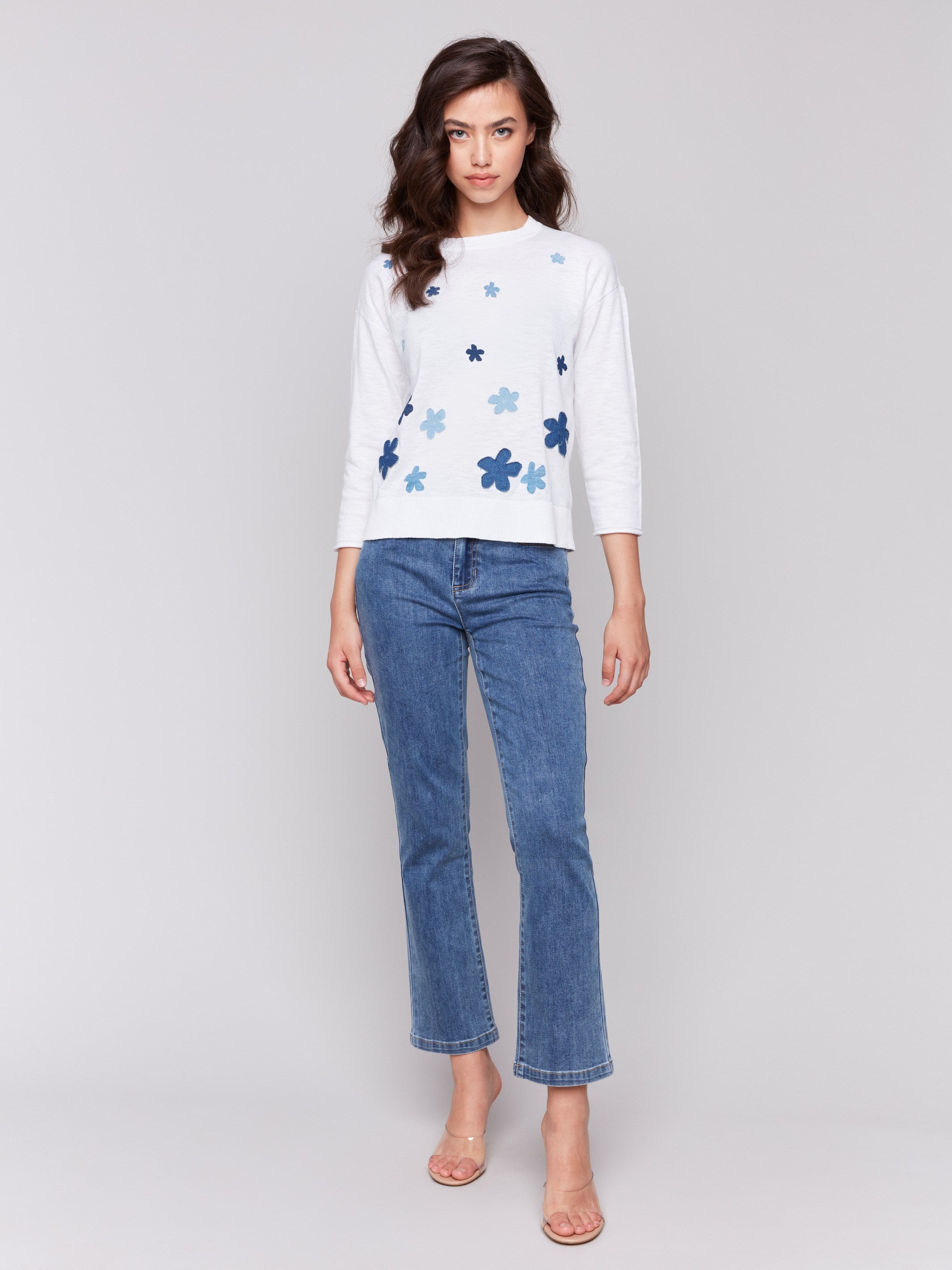 White cotton sweater adorned with unique denim floral patches by Charlie B.